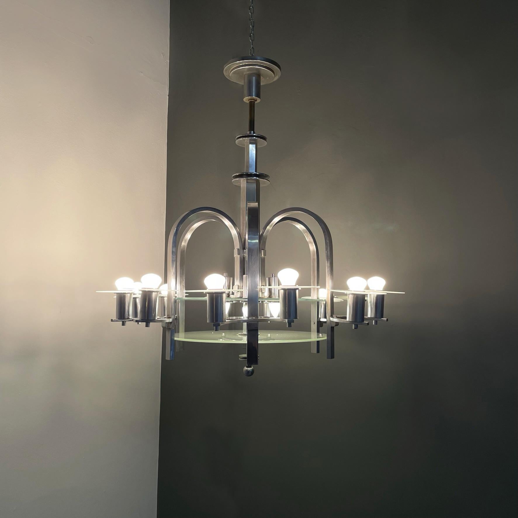 Austrian Art Deco Chandelier with twelve lights in metal and glass, 1920s
Chandelier with twelve lights in chromed steel and transparent and opaque glass. The central structure in metal with a square section has two discs in transparent and opaque