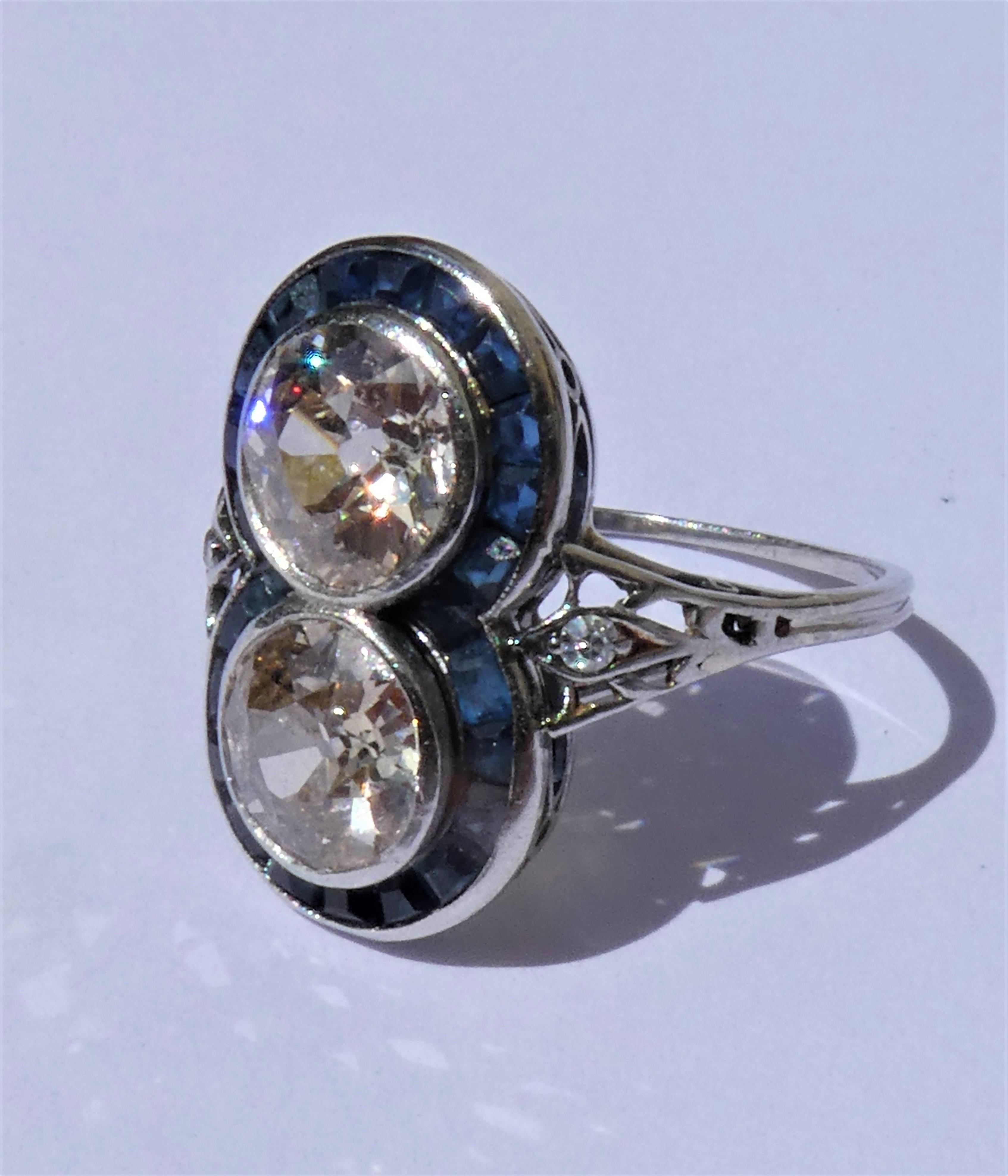 This lovely flat target ring was crafted in platinum in the 1920s. It has a platinum stamp and an Austrian hallmark in the shape of a butterfly. There are two round old European cut diamonds of circa 1.1 carat each, J - K colour, vvs1 - vvs2,