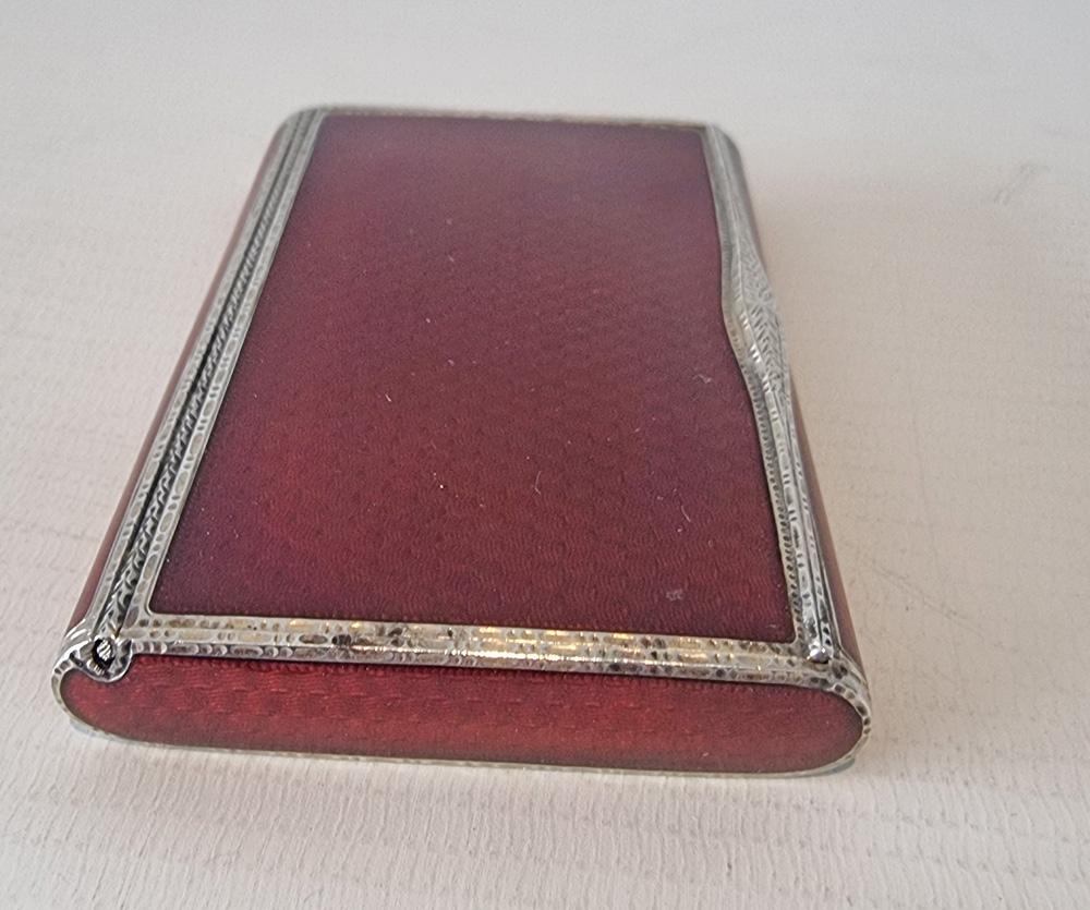 A superb Austrian Art Deco silver and red guilloche enamel cigarette or card case. Bearing full set of London import marks and date mark for 1928.  Extremely fine engine turned red guilloche enamel on all sides. Sponsors mark AJ.
