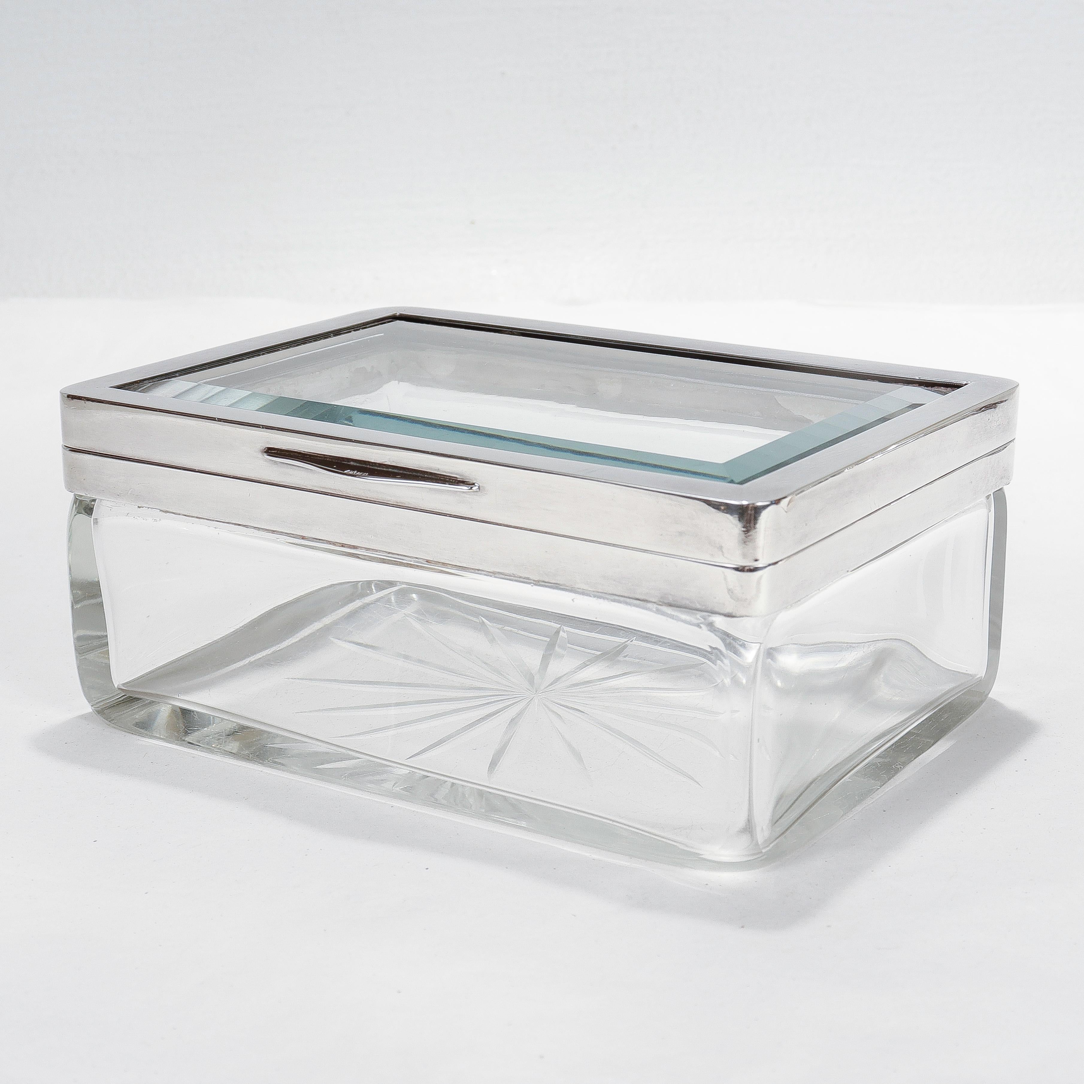 A fine antique Austrian casket or table box.

With a silver plate mount, a beveled glass insert top, and with a mold blown and cut body with a faceted star-cut pontil mark to its base.

Simply a wonderful Deco period box for the desk or table