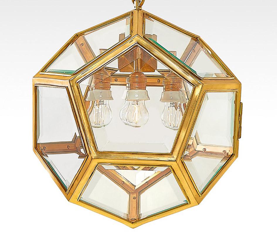 Original and rare Viennese Art Nouveau brass Dodekaeder pendant light designed by Adolf Loos, produced ca 1900 by Friedrich Otto Schmidt.
It features beautiful facetted cut pentagon glass and four bulb sockets.
It is in very good original condition,