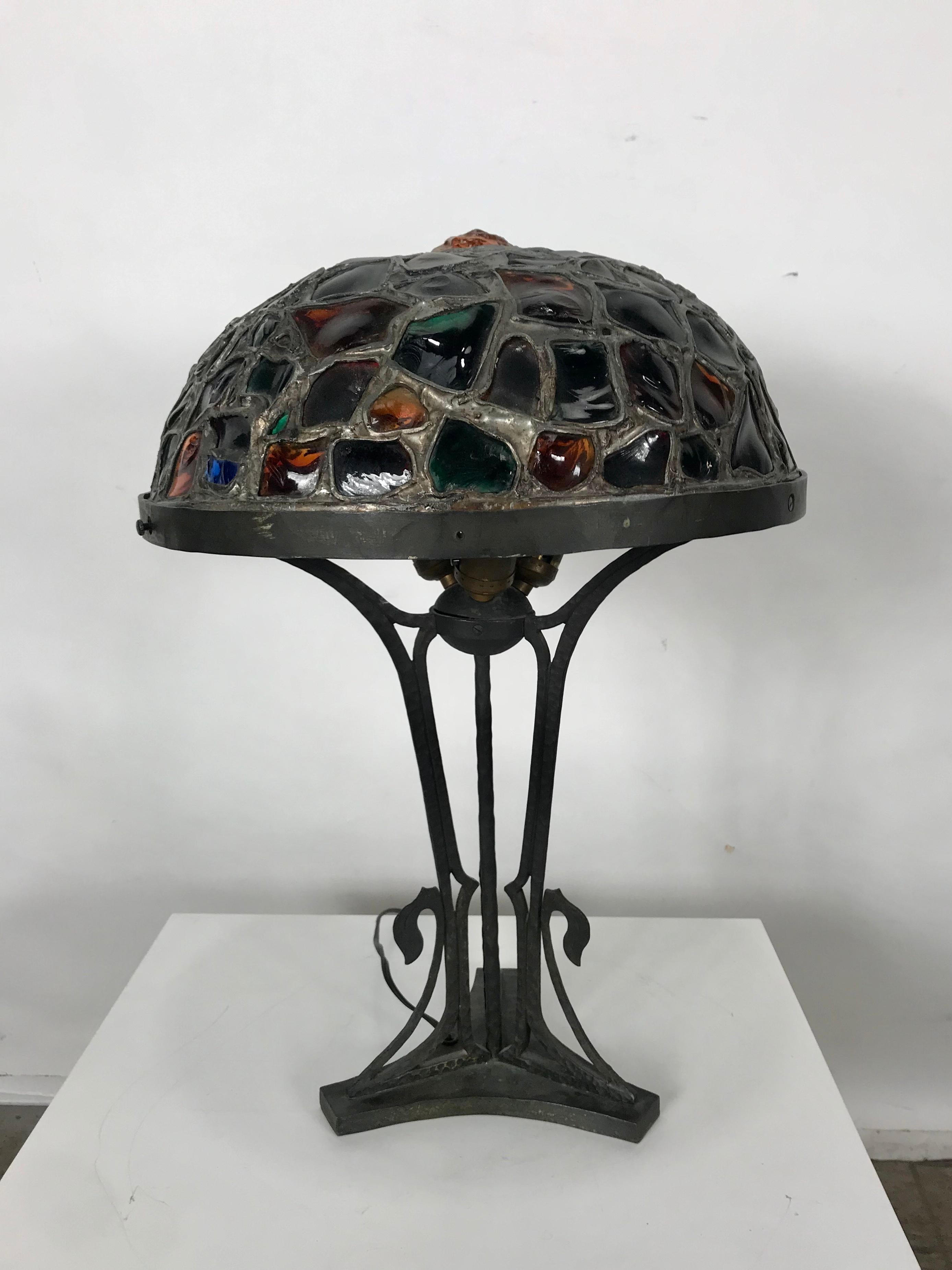 Austrian Art Nouveau bronze chunk glass table lamp, cast bronze with inserted chunk glass jewels in the shade, made in Austria in the 1900s, rewired. Wonderful patina to the metal surfaces,.