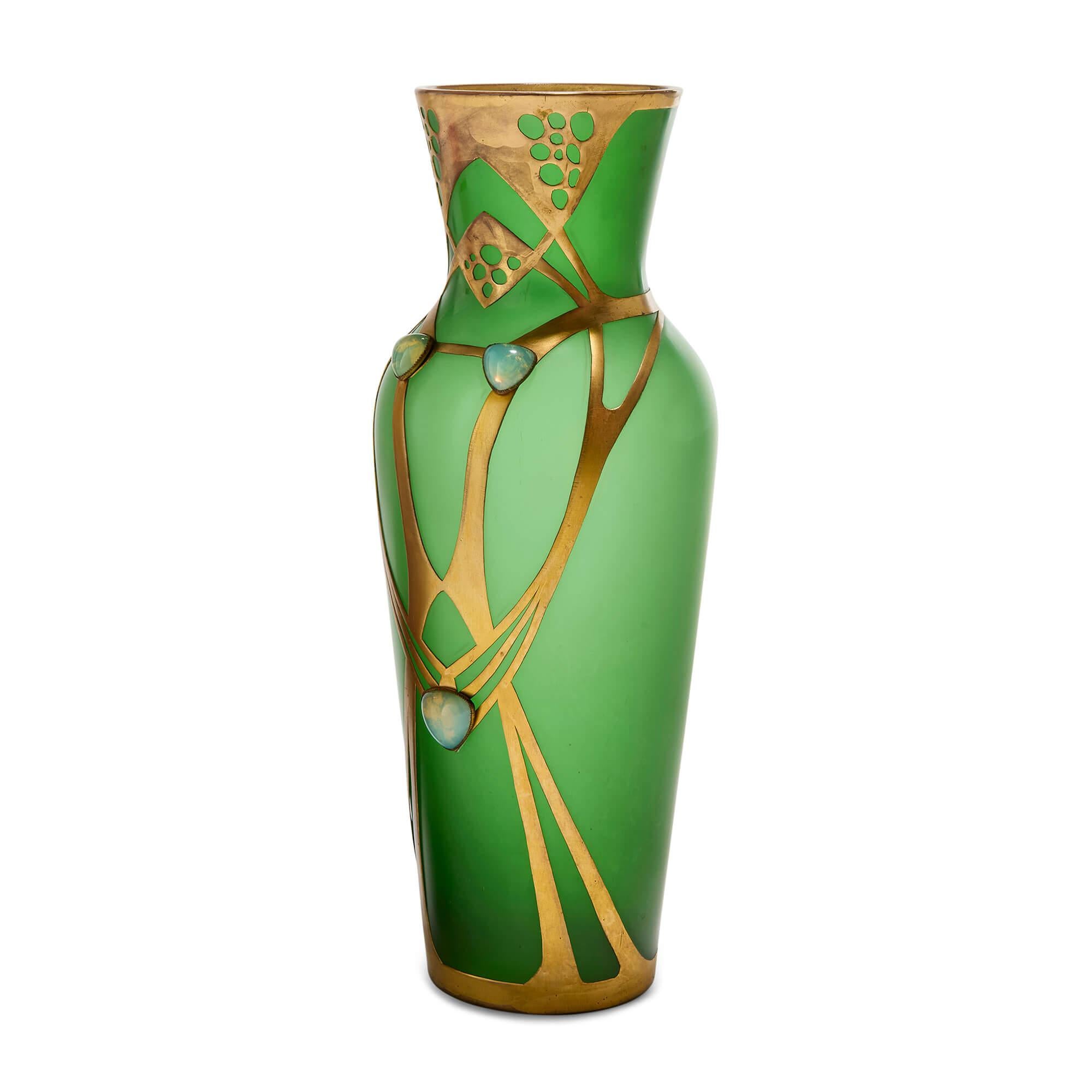 Austrian Art Nouveau Jugendstil gilt metal mounted green glass vase 
Austrian, c. 1910
Height 36cm, diameter 14cm

Dating to the early 20th century, this refined Austrian vase is a striking example of the Jugendstil movement - Austria’s distinct