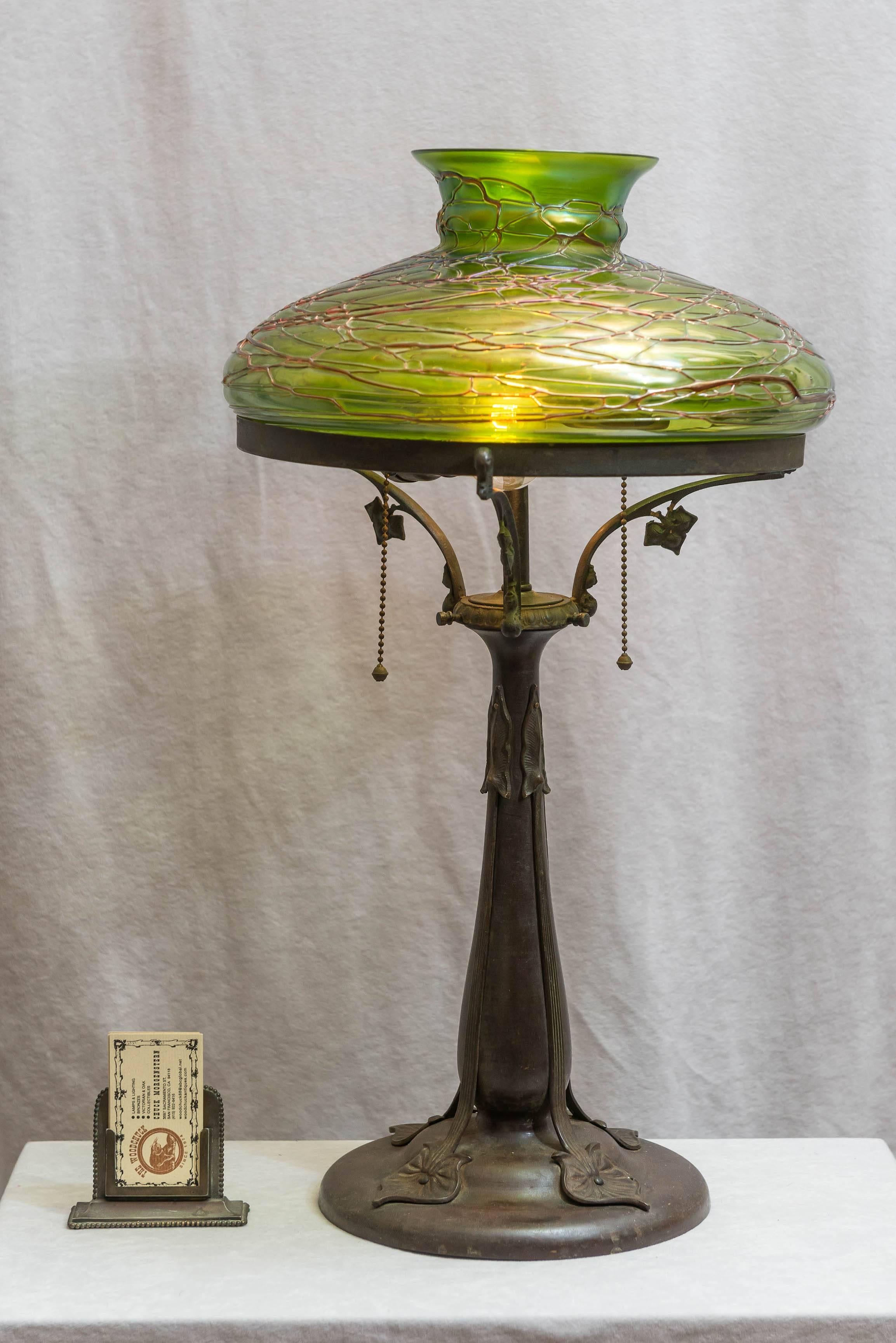 Very attractive Art Nouveau lamp with a handblown shade possibly executed by Loetz. The photos tell the story.