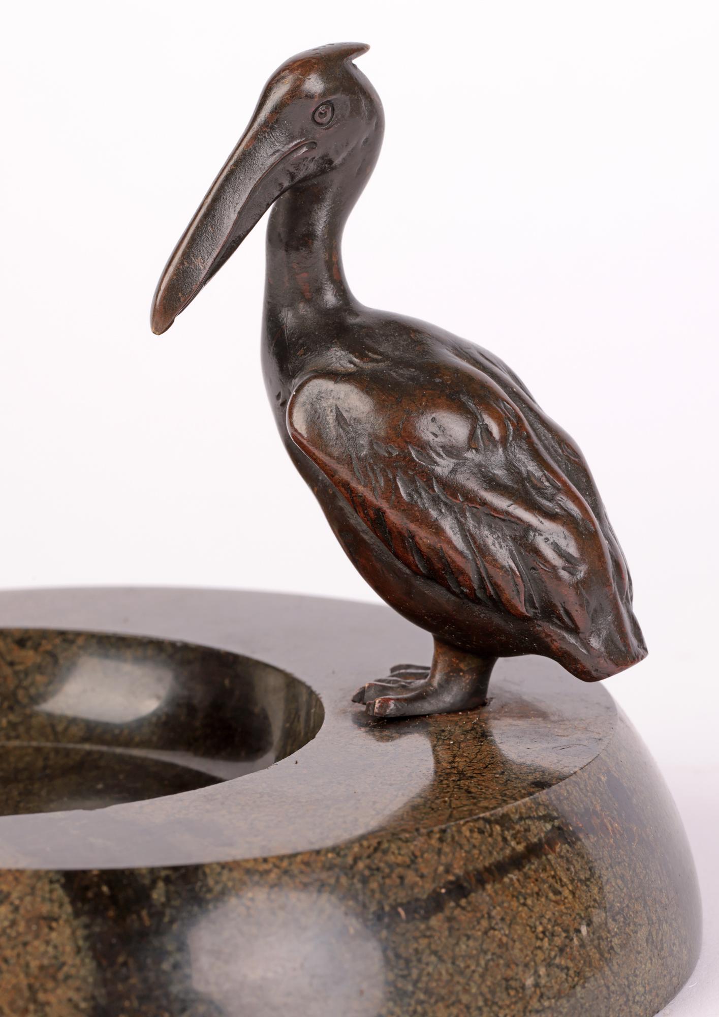 An exceptional and stunning early Art Deco, probably Austrian, bronze pelican mounted on a black veined green marble like dish dating from around 1920. The heavily polished dish is of rounded form with a shallow polished out recess located to the