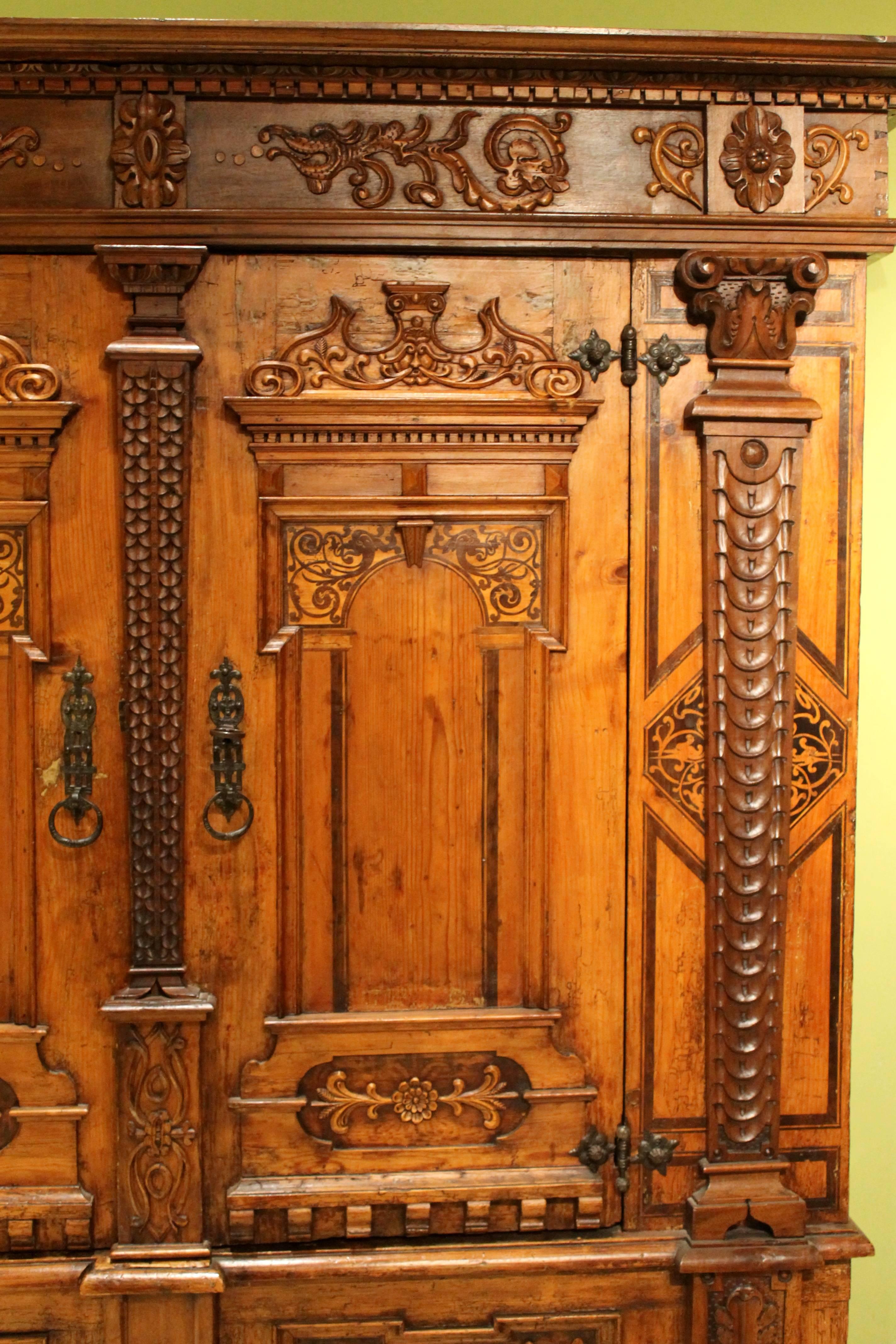 This exquisite Baroque period two doors armoire cabinet is made of light caramel-colored walnut wood and solid birch wood core with intricately and precious oak moulding decoration throughout. This luxury architecturally structured cabinet features