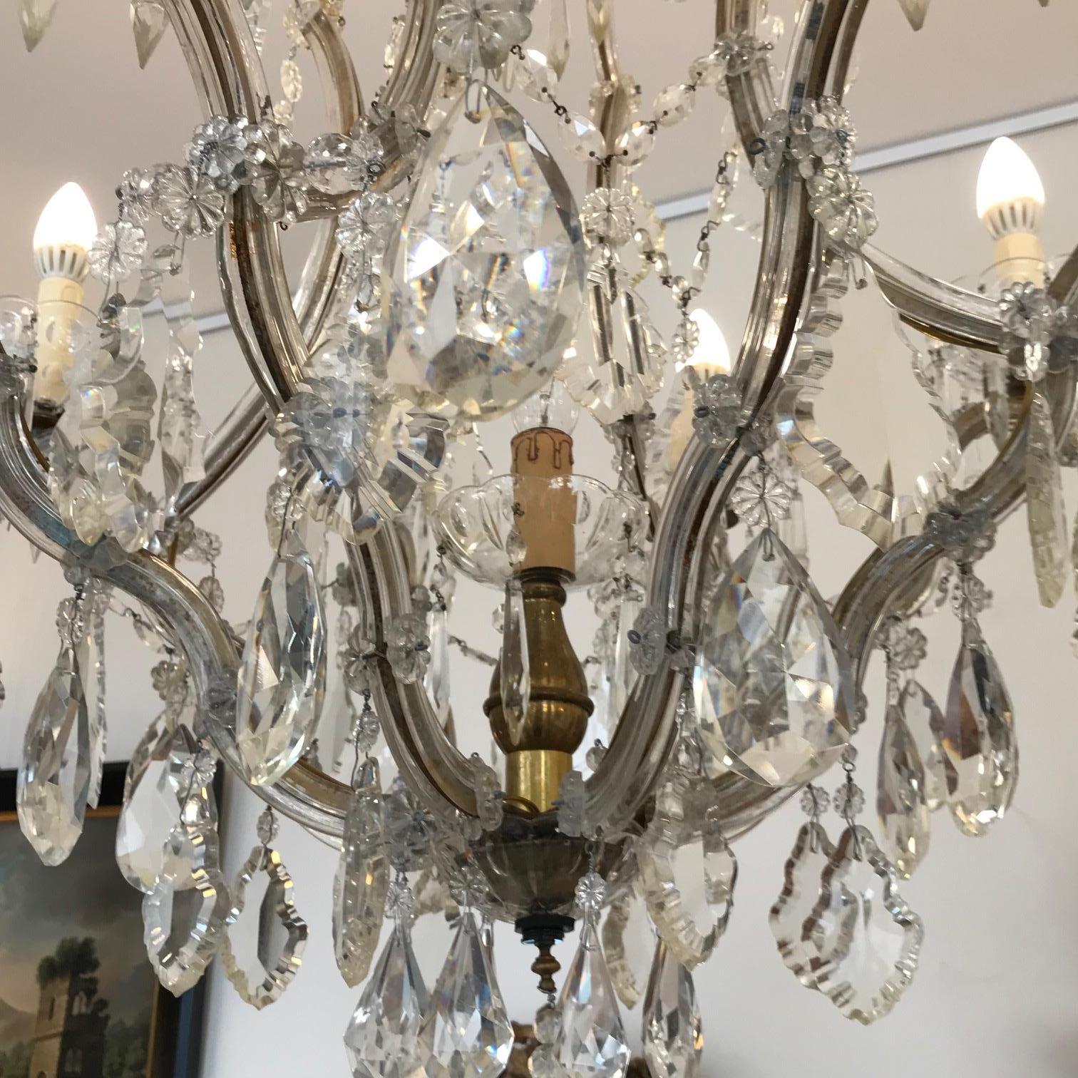 Austrian Maria Theresa style chandelier with hand-forget gilt metal basket shape frame sheathed in hand catted glass. Inside of 6 candle arms is a central light.