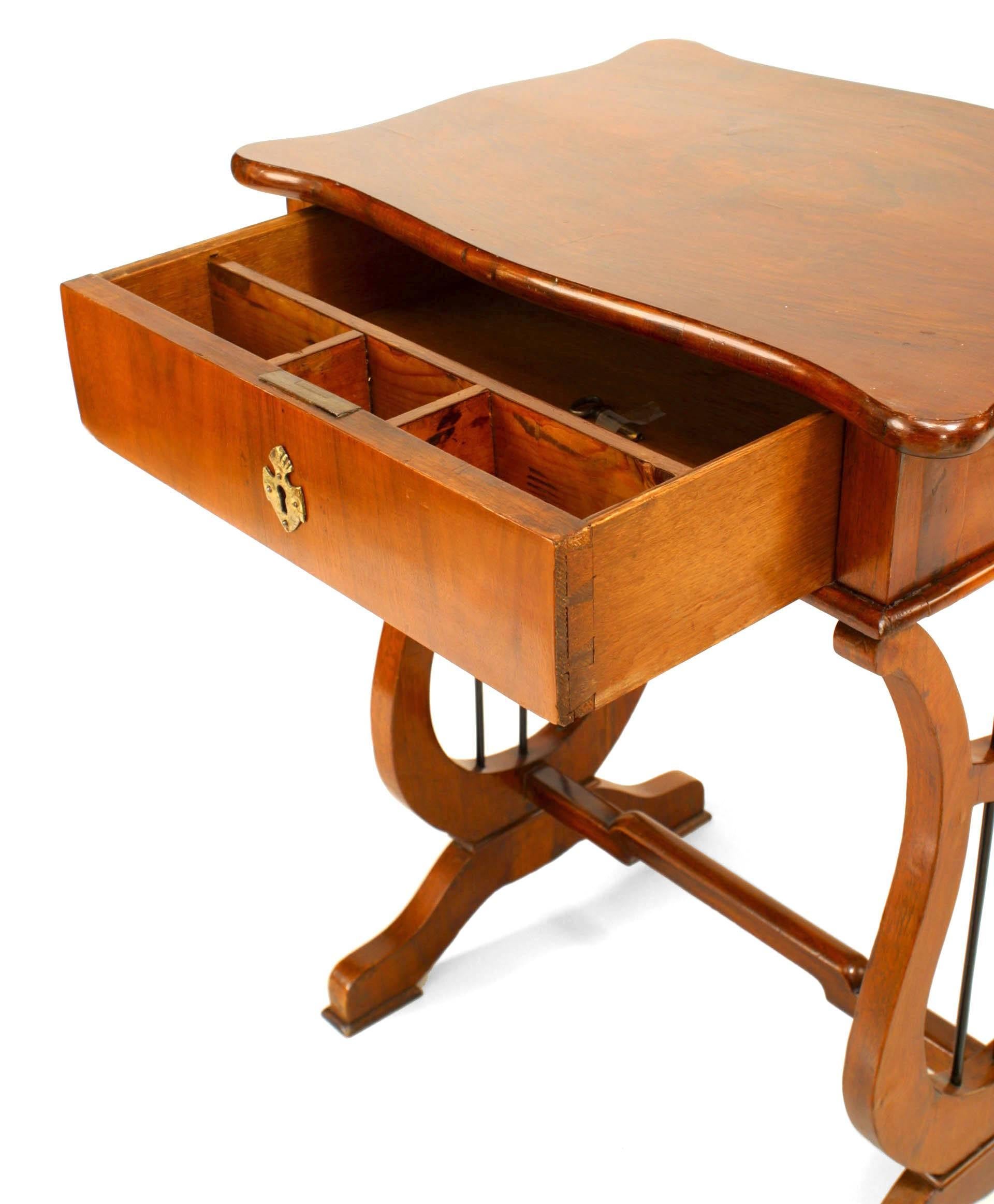 Austrian Biedermeier (19th Century) mahogany end table with a drawer and lyre form pedestal sides connected with a bottom stretcher.
