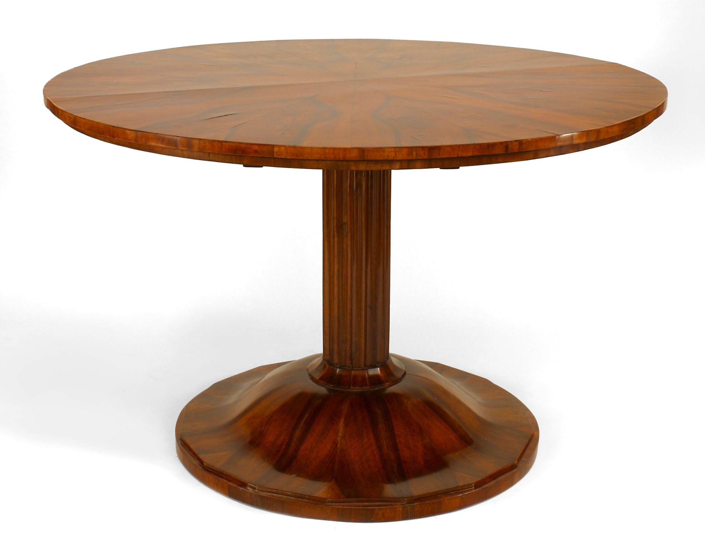 Round nineteenth century Austrian Biedermeier book matched walnut veneered center table supported by a fluted pedestal and a round, scalloped platform base.