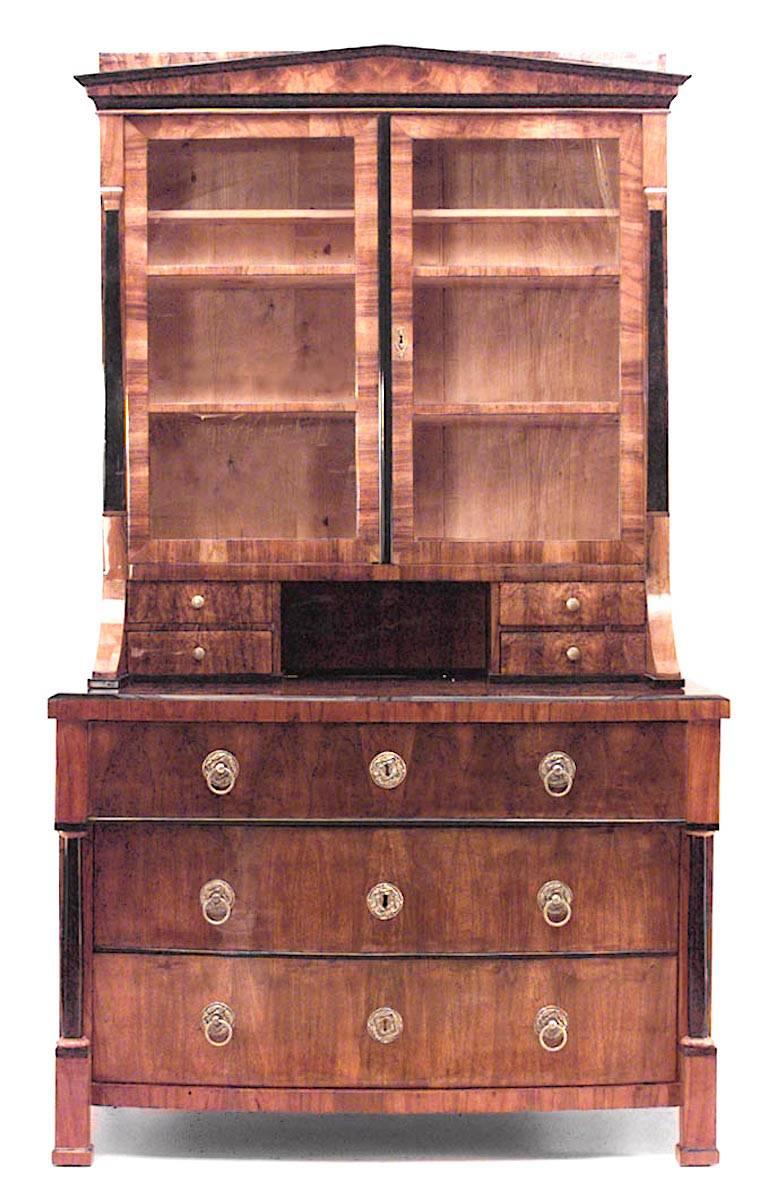 Austrian Biedermeier (Circa 1825) walnut veneer and ebonized trimmed bookcase with demilune 3 drawer commode base and upper section with 2 doors and 4 small drawers.
