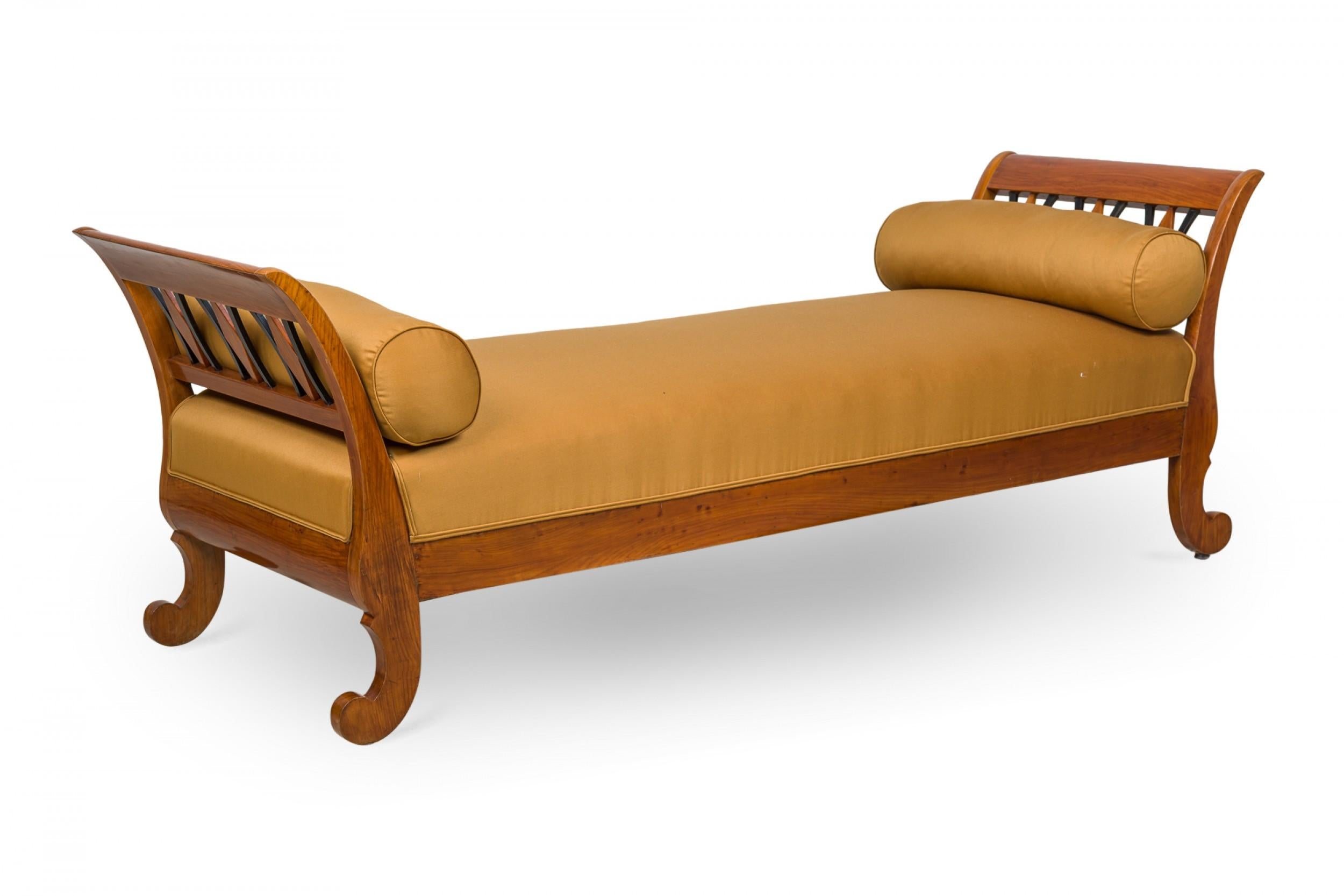 Austrian Biedermeier (circa 1830) cherrywood daybed with open design black trimmed sides on scroll legs with white upholstered seat and 2 bolsters
