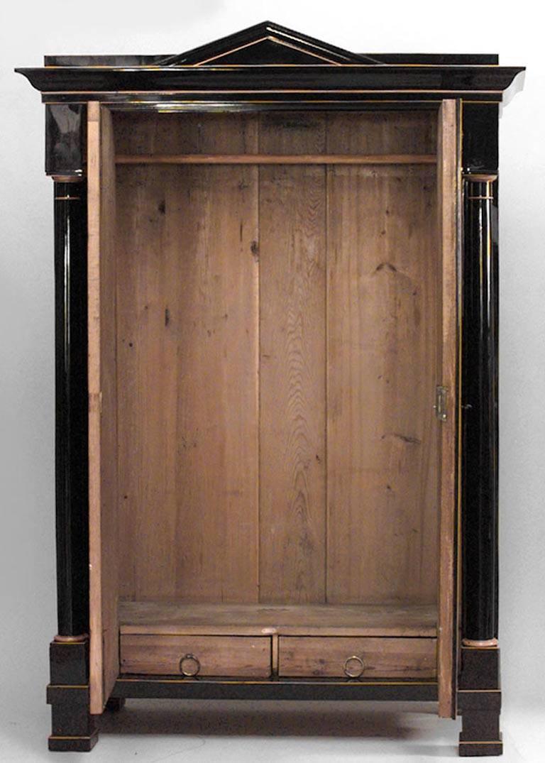 Austrian Biedermeier (Empire) ebonized and maple inlaid trimmed armoire cabinet with two doors and pediment top, circa 1815.
   