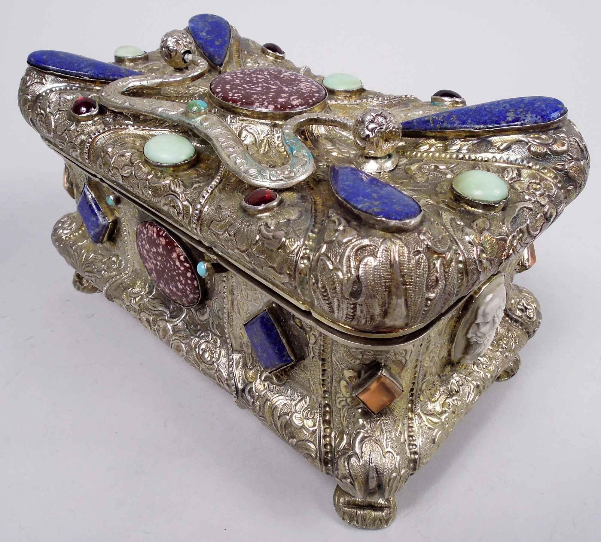 Austrian Biedermeier silver gilt casket, 1846. Bellied, lobed, and rectangular. Hinged cover same and concave with raised center and swing-mounted scroll bracket cast handle with flowers. Hardstone mounts including porphyry and lapis lazuli as well