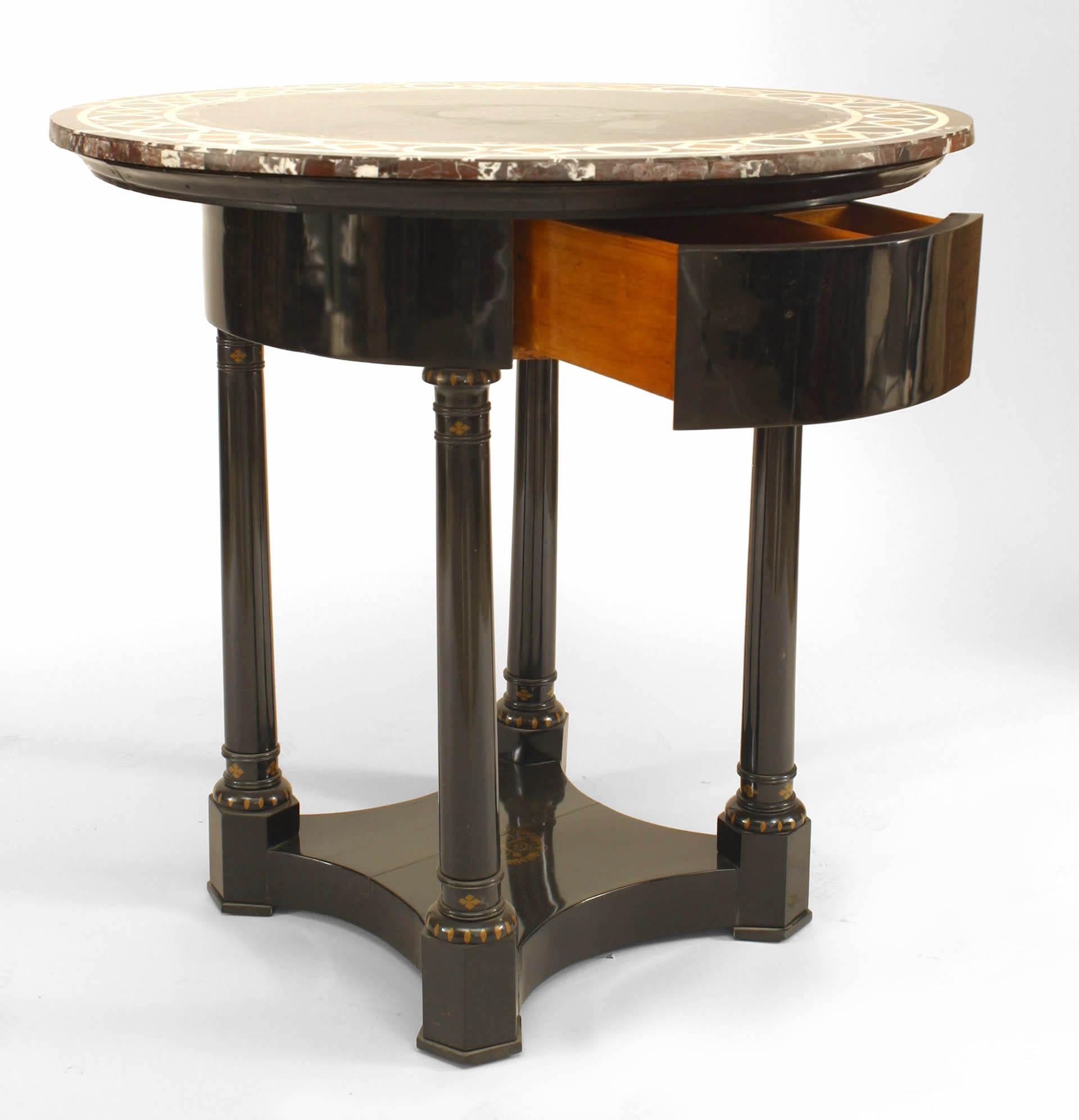 Austrian Biedermeier (circa 1820) round ebonized center table with inlaid marble top & drawer supported by 4 columns ending in a platform base with gold stenciled decoration.
