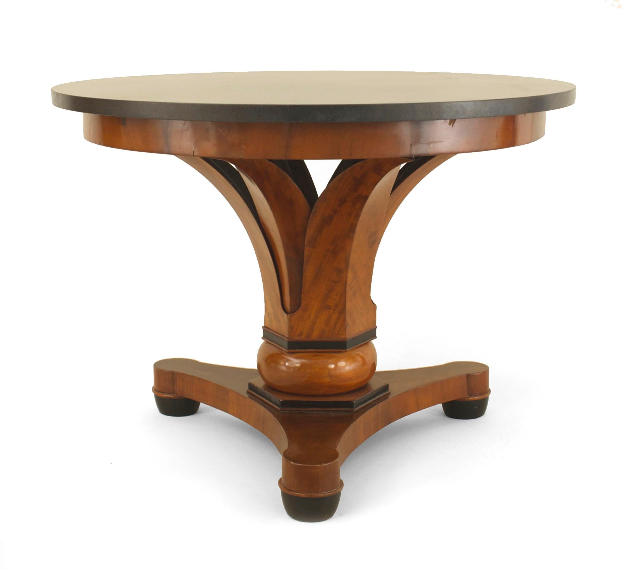 Austrian Biedermeier (circa 1830) black round marble topped mahogany center table having a palm leaf support over a tripartite base on padded feet.
