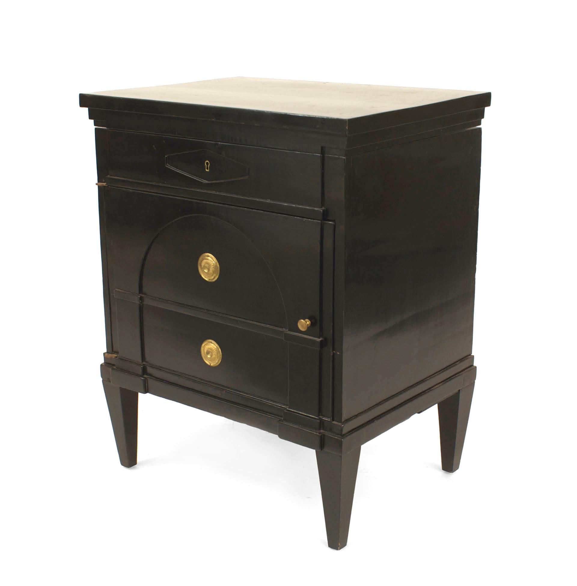 Austrian Biedermeier style (20th Century) ebonized commode with a bottom door revealing 2 shelves and a top faux drawer with a lift top.
