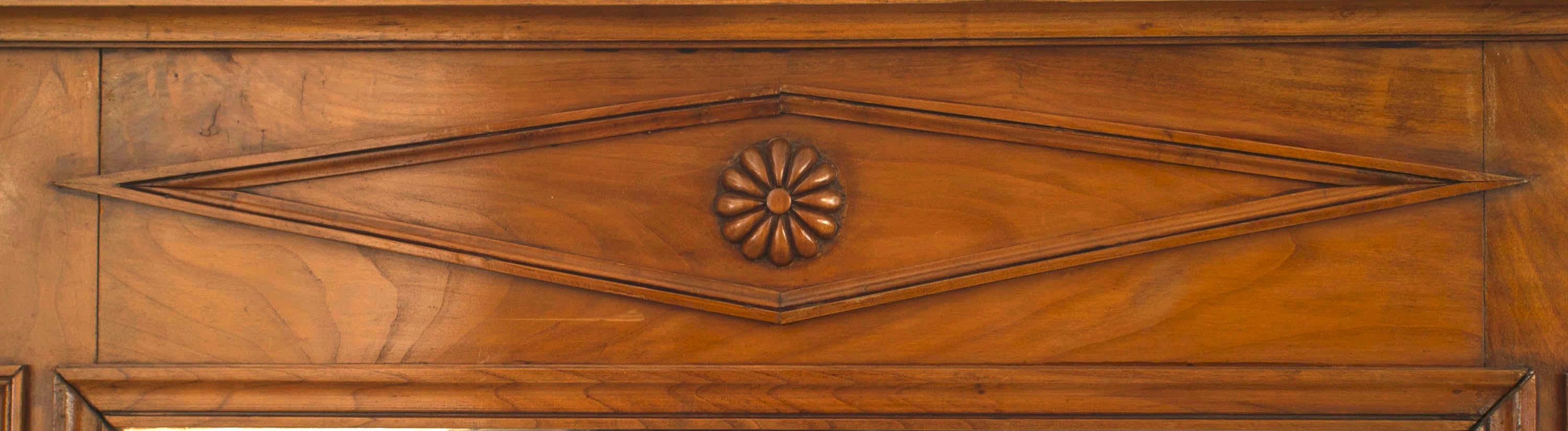 Austrian Biedermeier-style vertical fruitwood wall mirror with paneled sides and a diamond design motif on top.
