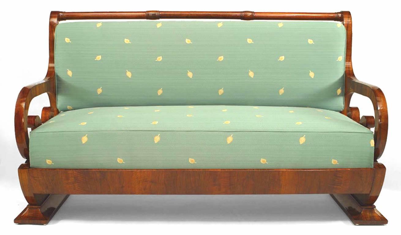 Austrian Biedermeier walnut veneered settee with open double scroll design arms resting on a fluted ¬Ω round shaped base with upholstered seat & sleigh back (Circa 1825)
