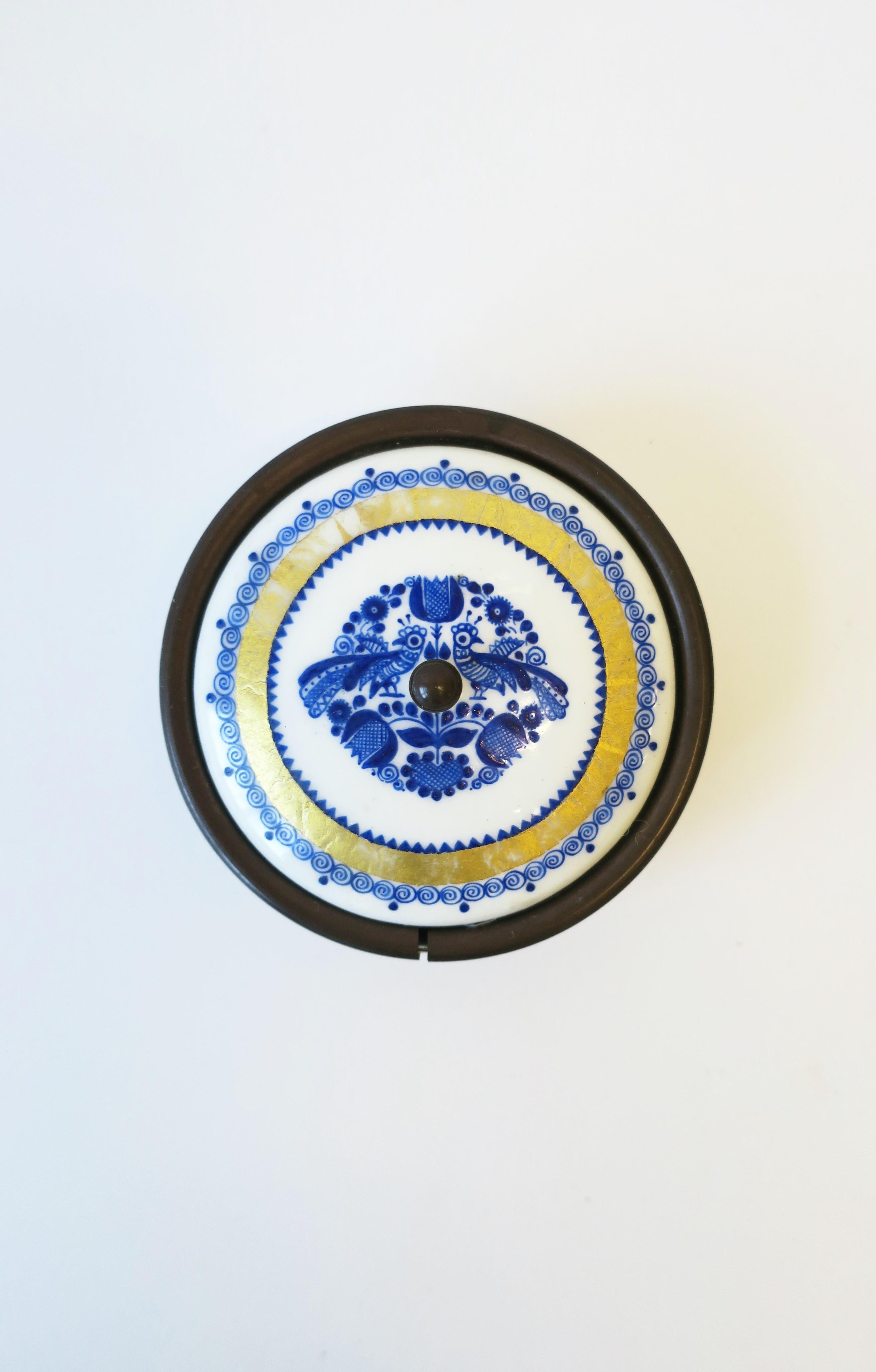 An Austrian blue, white, and gold porcelain enamel small box and lid by Black, Starr & Gorham, circa early-20th century, Austria. Box has detailed design of peacock birds, flowers, leaves and swirls. Marked 'Black, Starr & Gorham', 'Austria', on