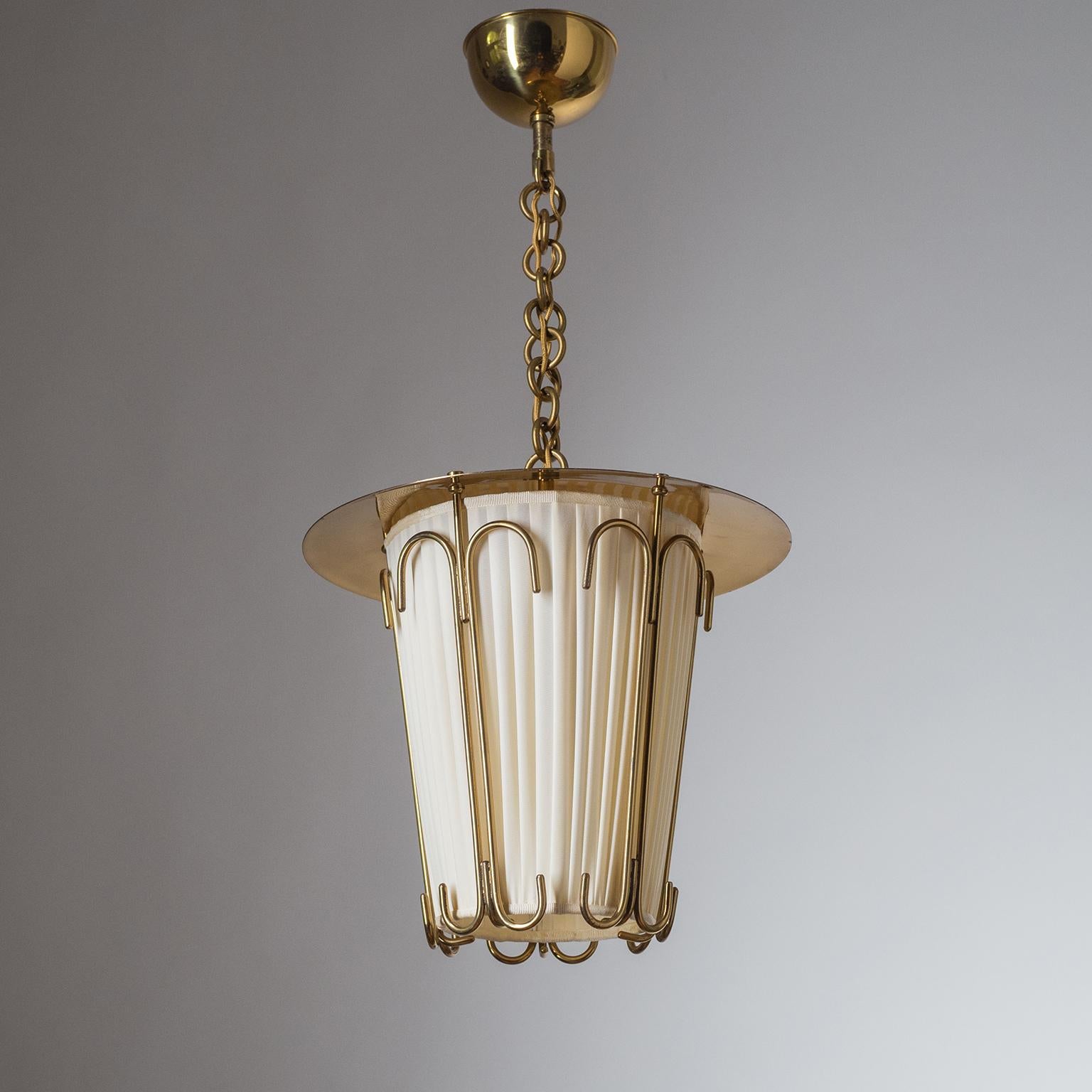 Rare Austrian brass lantern from the 1940s, attributed to J.T. Kalmar. The pleated shade diffuser is held by five ornamental brass elements. One original brass and ceramic E27 socket with new wiring.