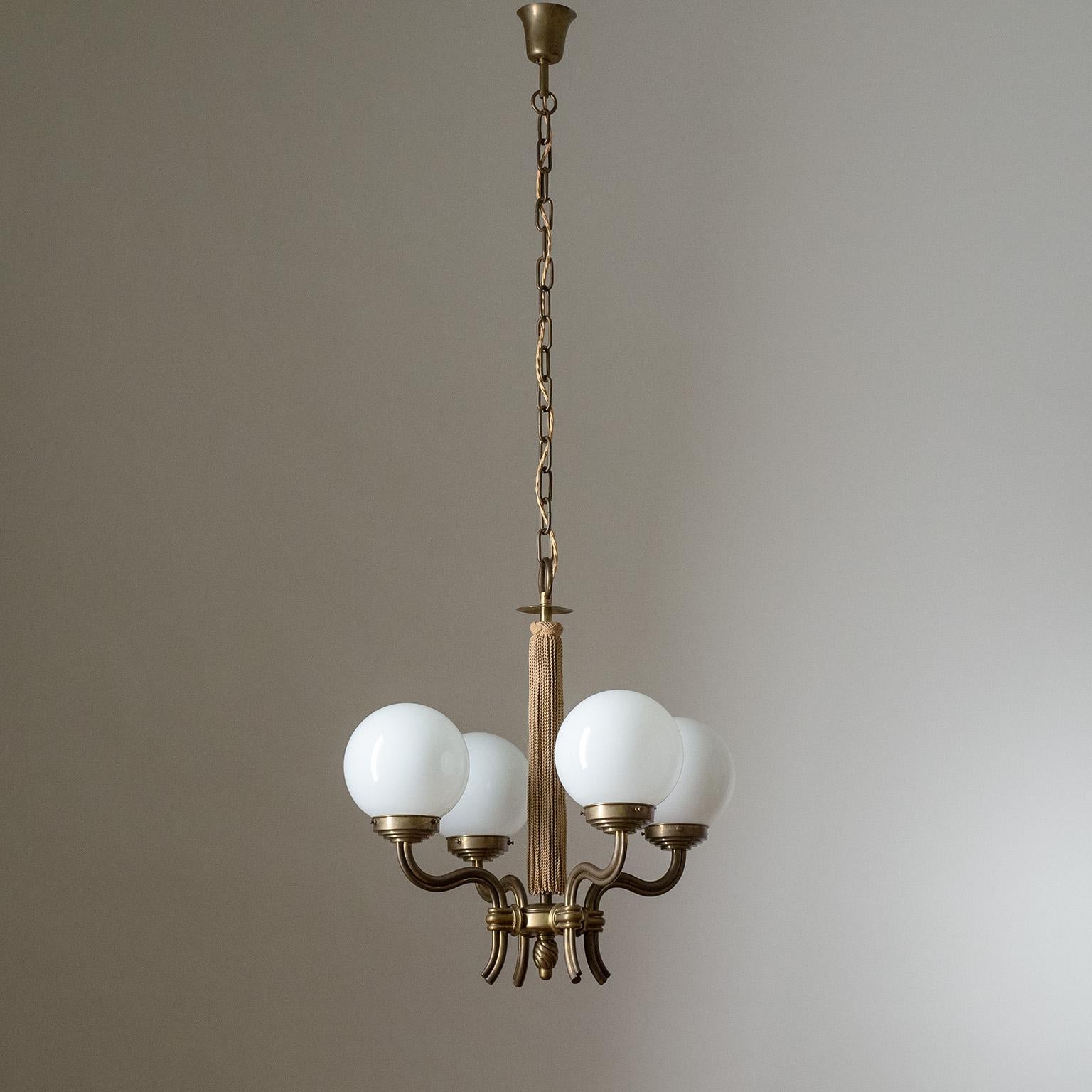 Fine Austrian brass chandelier from the 1930s. Lovely curved and profiled brass arms each with an original blown glass globe (16cm/6″). Central stem with original tassel and long chain which can be shortened. Four original brass and ceramic E27