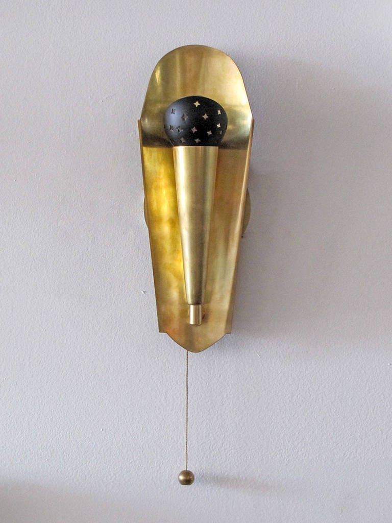 Playful pair of Austrian brass wall lights, featuring black enameled shade inserts with unique star perforations, fitted with individual on/off pull switch on either wall light. One E12 socket per fixture, max. Wattage 40w each, bulbs provided as a
