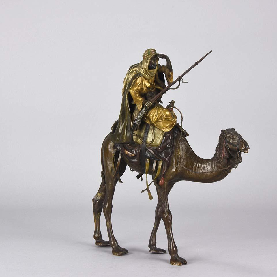 Very impressive large cold painted Austrian bronze group of an Arab warrior holding his rifle and looking into the distance whilst mounted on his camel, carrying various accoutrements. The detailed surface with fine hand chased workmanship