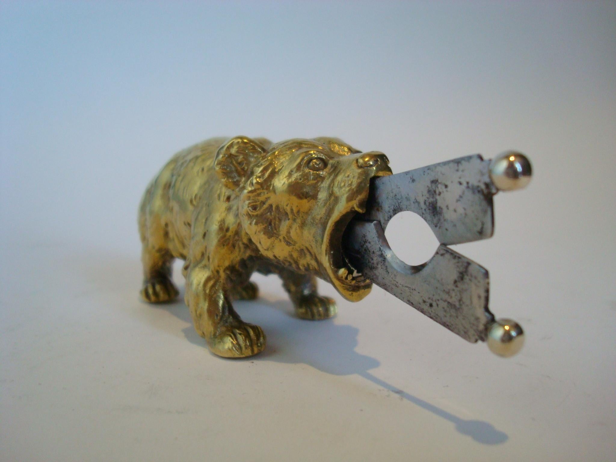 A solid bronze bear sculpture desktop cigar cutter manufactured in Austria. The scissor action steel blades are remove-able form the mouth of the roaring bear. Excellent condition. Solid Bronze
Retractible hidden cigar cutting steel blades. Perfect