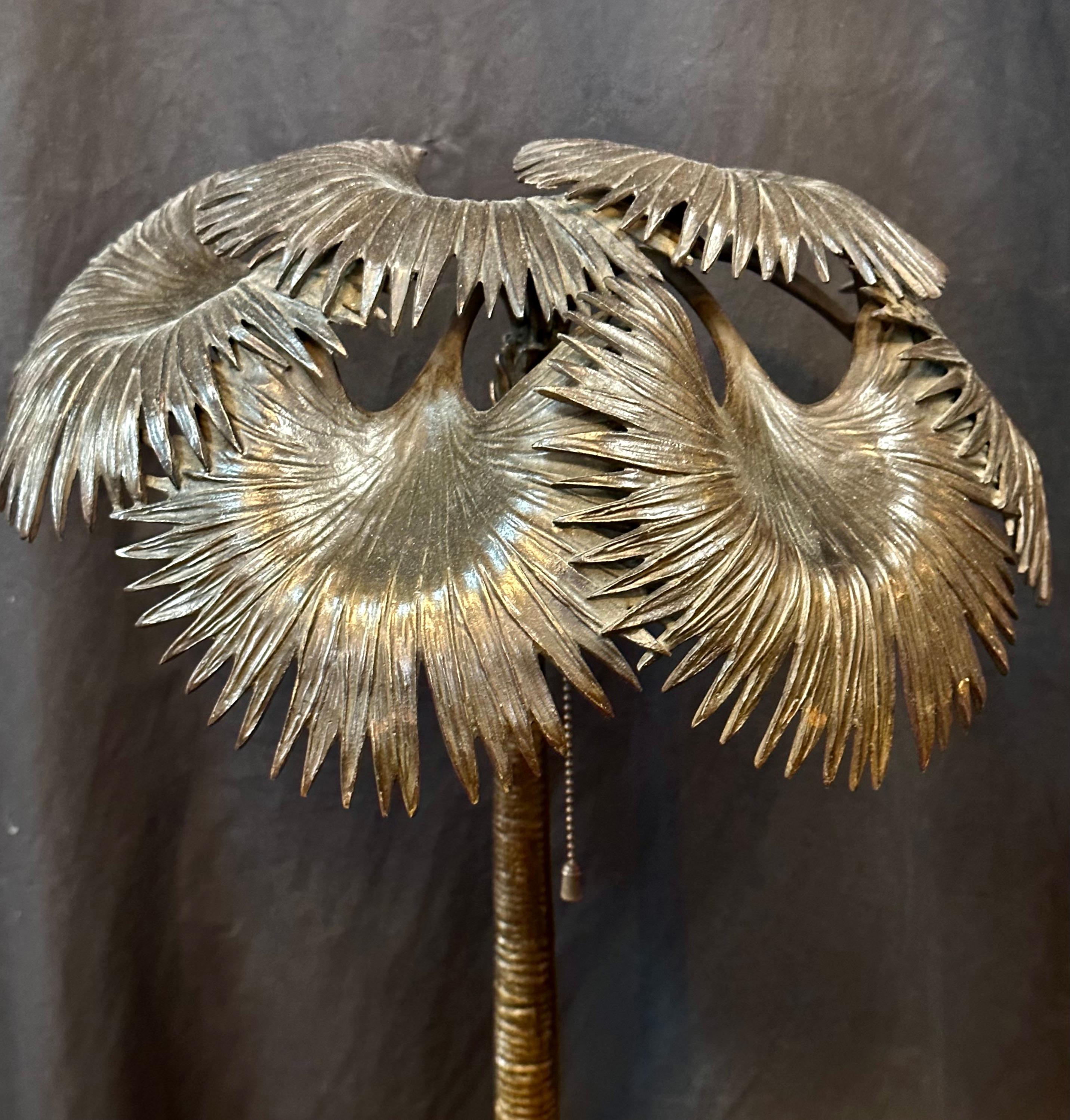 This vintage early 20th century Austrian bronze lamp is beautifully sculpted with two elephants under a palm tree. It has a naturalistic looking base that is stamped AUSTRIA. The sculpture is reminiscent of a Bergman bronze creation, but it is