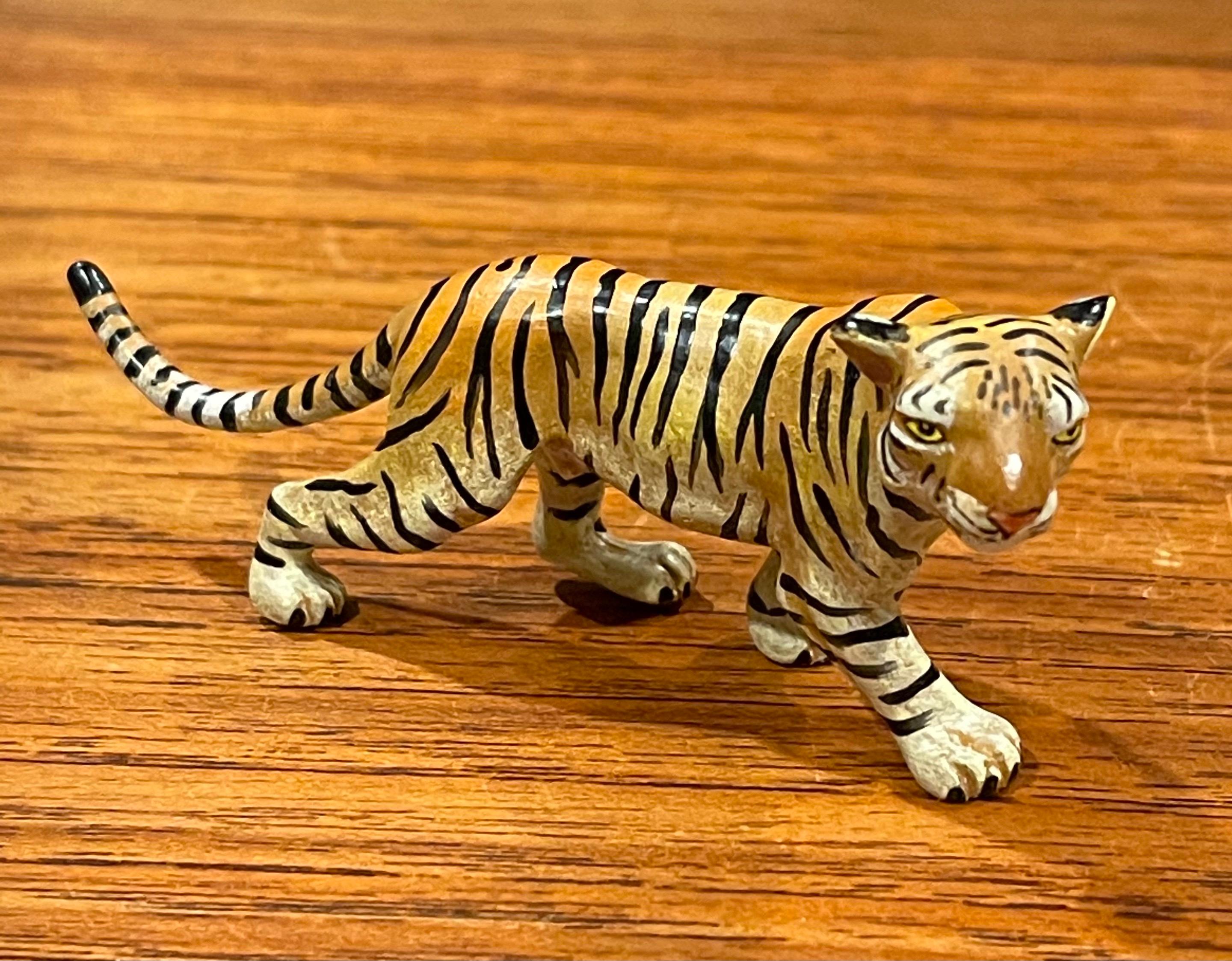 Austrian bronze hand painted miniature tiger sculpture, circa 2000s. This piece has amazing detail and weight and is in excellent condition. The sculptureis individually cast from sand molds that are used only once, then sculpted and hand painted