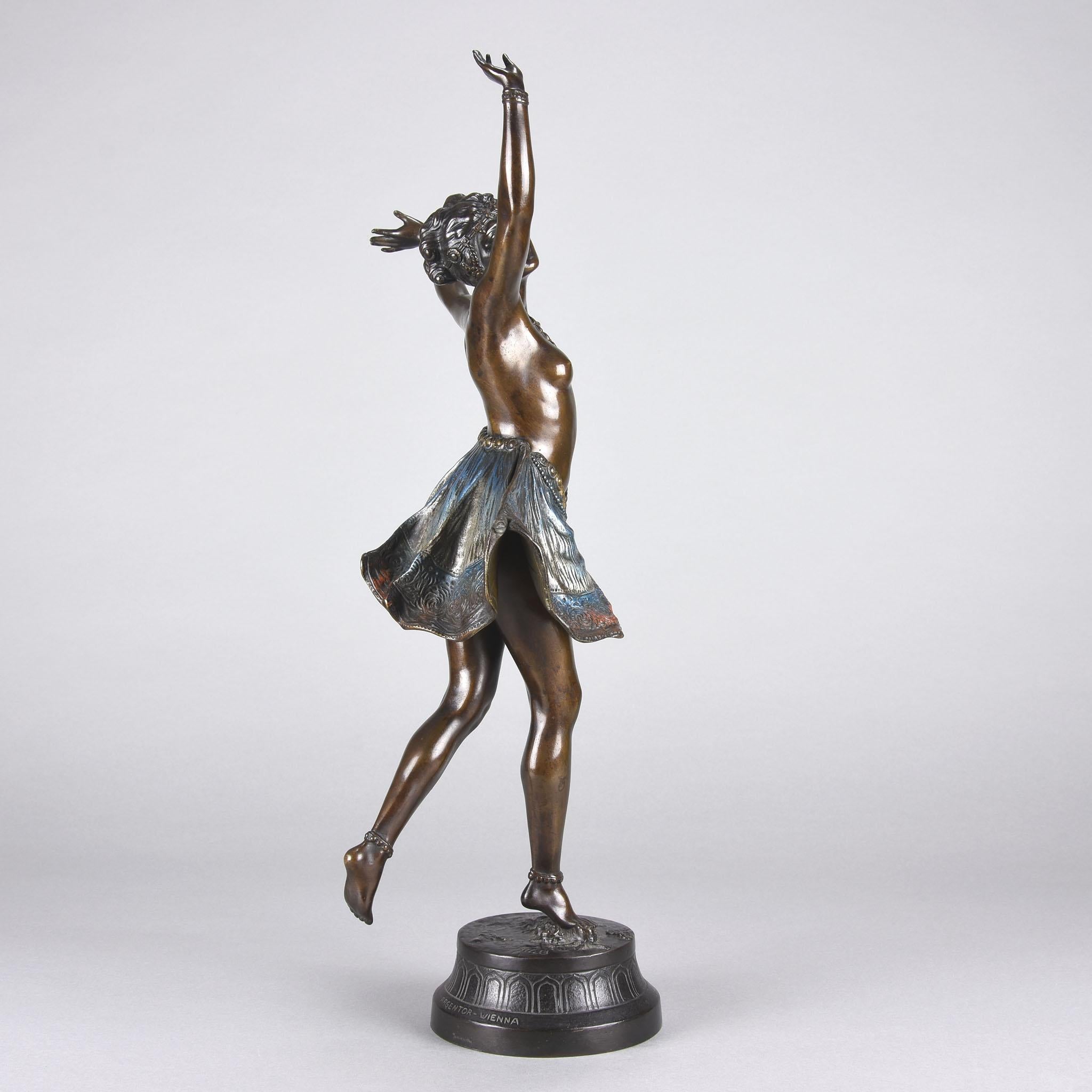 A beautiful early 20th century cold painted Austrian bronze study of young semi clad dancer wearing only a skirt which is mechanically hinged to reveal her naked body creating the illusion of butterfly wings. Raised on a decorative bronze base,