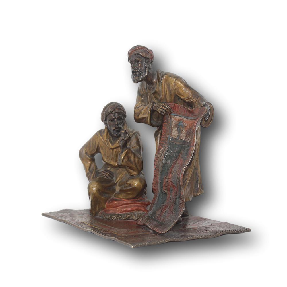 Fine Austrian cold painted bronze figure of a pair of carpet sellers. One figure stand's displaying a carpet on offer while the other sits seated upon a carpet while smoking a pipe. The piece unsigned but undoubtedly the work of Franz Bergman due to