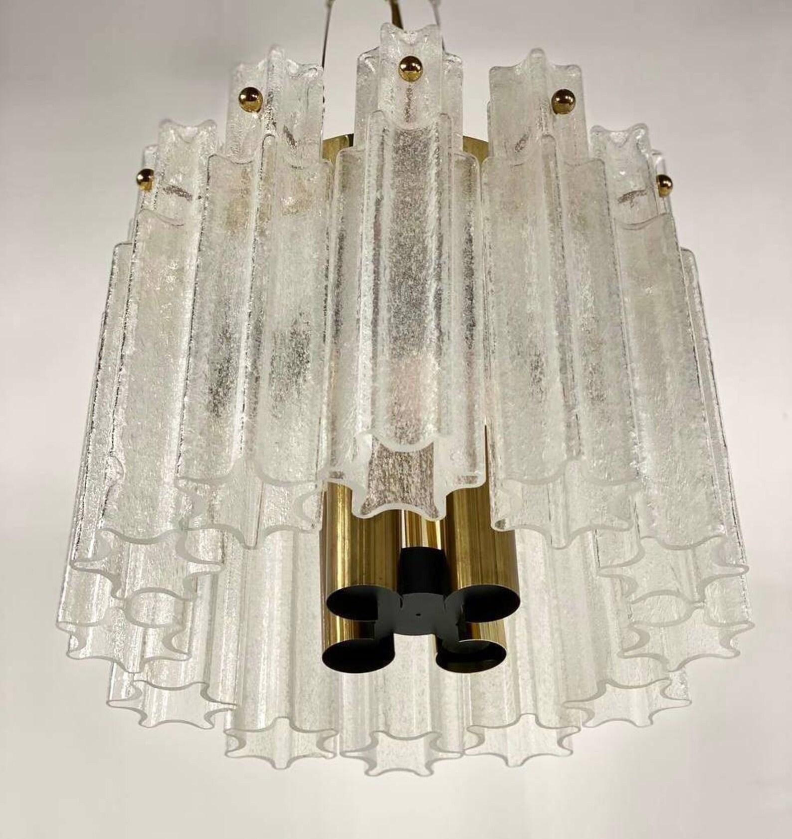 Vintage chandelier from Kalmar Lighting, 1970s. 

A beautiful pendant light, manufactured by Kalmar Austria, in the 1970s.

The suspensions of the luxurious designer chandelier are made of many glass long tubes resembling stars. Grooved hangers,