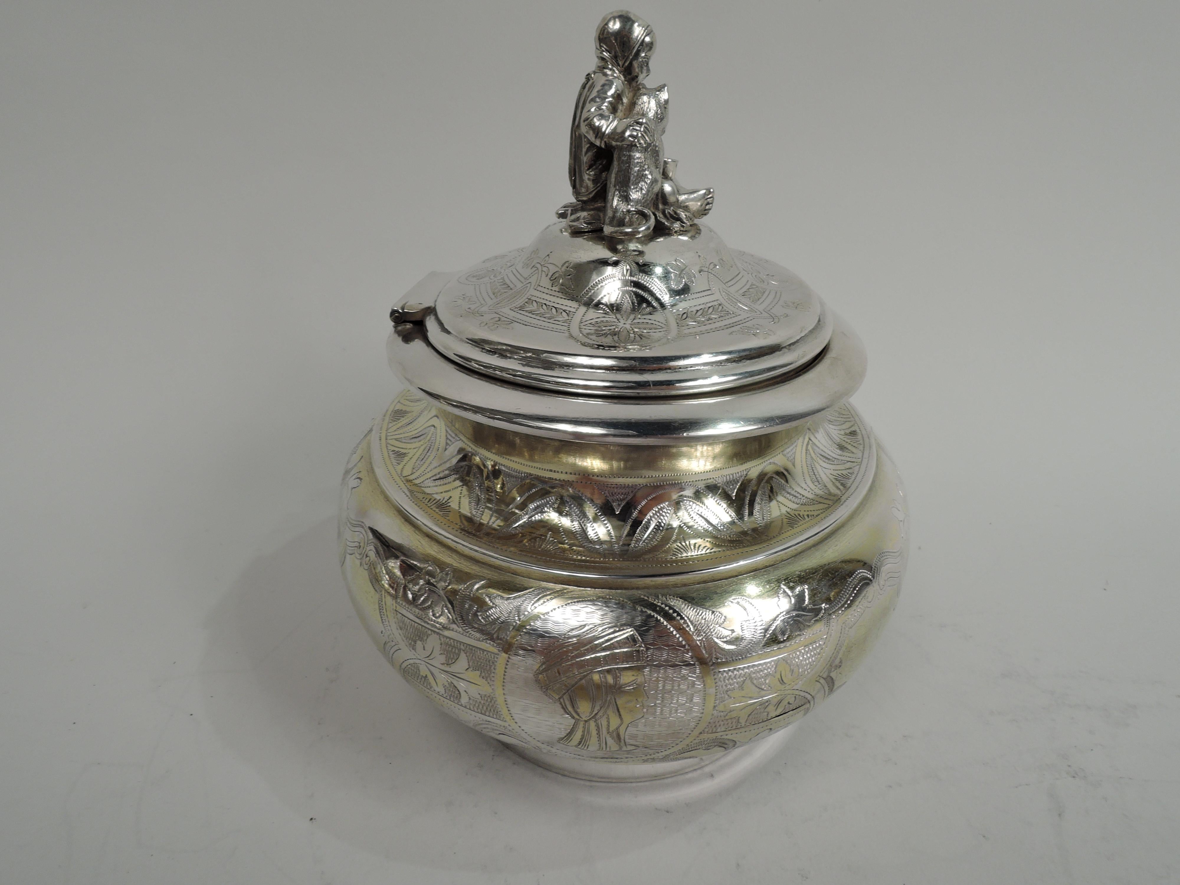 Antique Austrian Classical gilt-washed 800 silver box, ca 1875. Ovoid and bellied on plain inset foot. Cover hinged and domed with cast figural finial: A little girl sits cross-legged and barefoot and rests her hand on the back of a hungry animal
