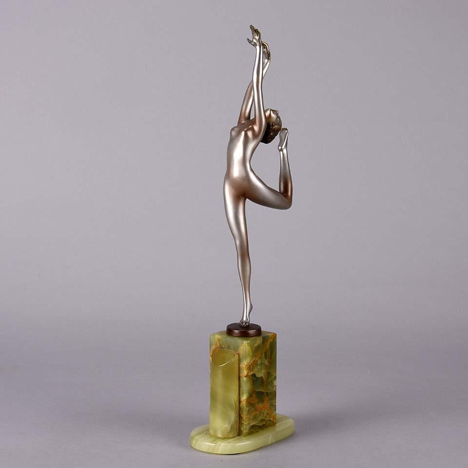 An energetic cold painted Art Deco bronze figure of a beautiful naked dancer holding an elegant stretched pose, the silver colour heightened with shading. The figurine raised on a Brazilian green onyx base and signed Lorenzl 

Josef Lorenzl ~