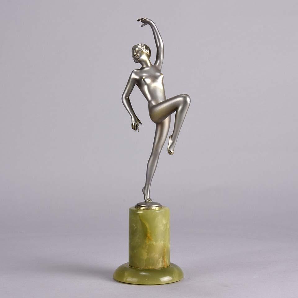 An elegant Art Deco cold painted bronze figurine of a beautiful dancer with her arm and leg raised in an exaggerated pose, exhibiting Fine colour and good hand finished detail, raised on a Brazilian green onyx base and signed Lorenzl 



Josef