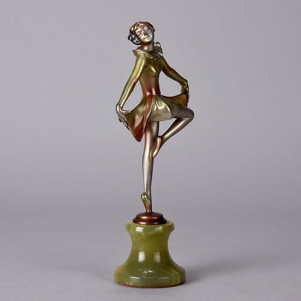 A striking cold painted bronze figure of an Art Deco dancer in a balanced pose holding the hem of a skirt , exhibiting very Fine colour and good hand finished detail, raised on a Brazilian green onyx base and signed Lorenzl

Josef Lorenzl ~