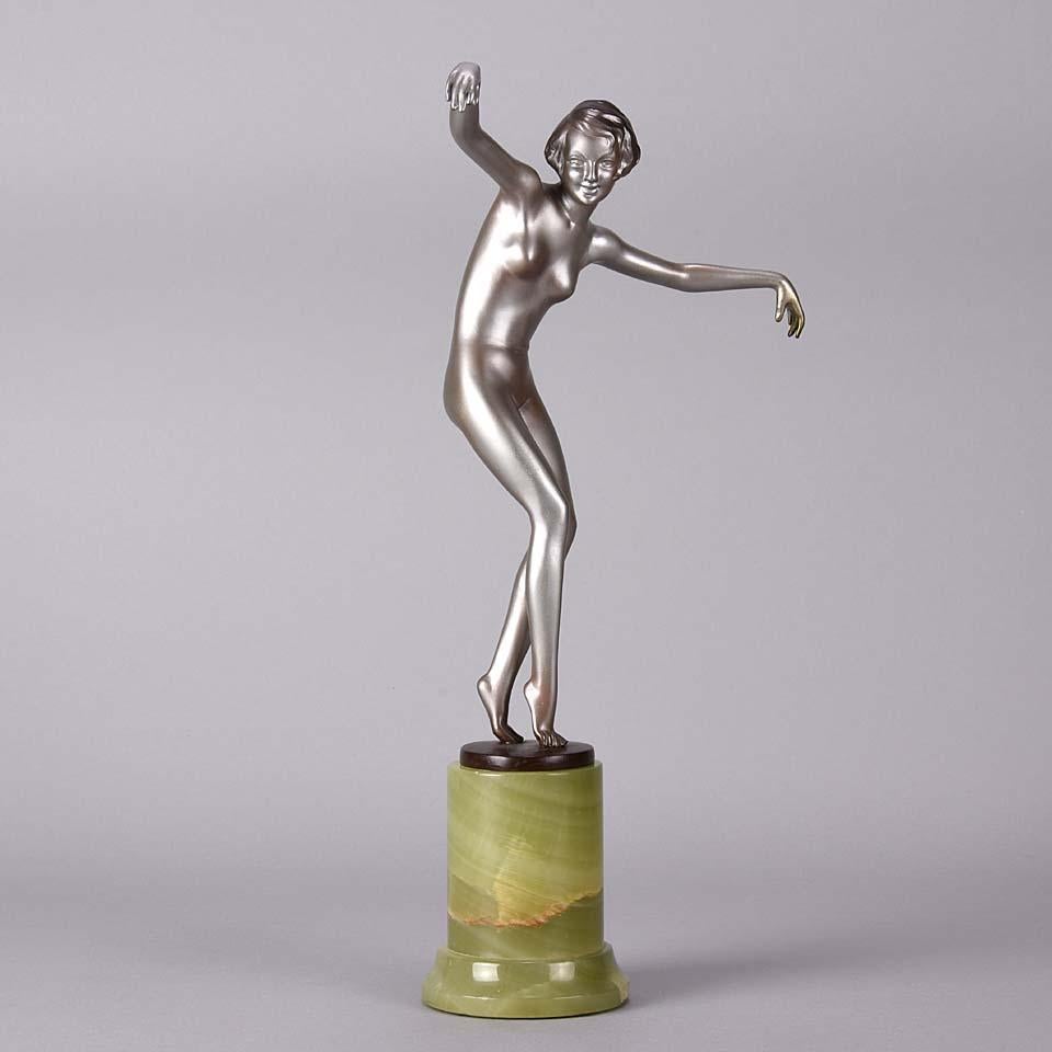 An elegant cold painted bronze figure of an Art Deco dancer in an exaggerated pose with both arms raised, exhibiting fine colour and good hand finished detail, raised on a Brazilian onyx base and signed Lorenzl



Josef Lorenzl ~ Austrian,