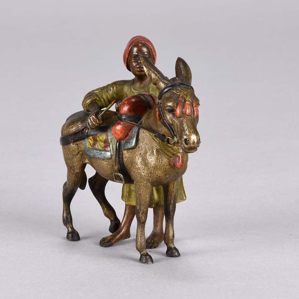 Wonderful cold painted Austrian bronze group of a young Arab boy standing next to his faithful donkey carrying his goods, finished with very fine hand chased detail and excellent colors, stamped with Bergman ‘B’ in a vase

Franz Bergman Bohemian,