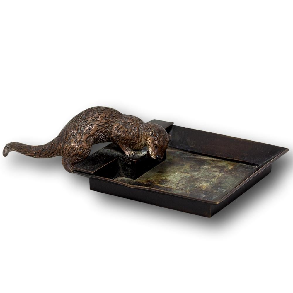 A charming Austrian cold painted bronze desk tidy of an otter. The tray of square form with an otter to one side perching above the tray simulating the otter looking into water. The tray with multiple uses from a desk tidy to a key dish dating to