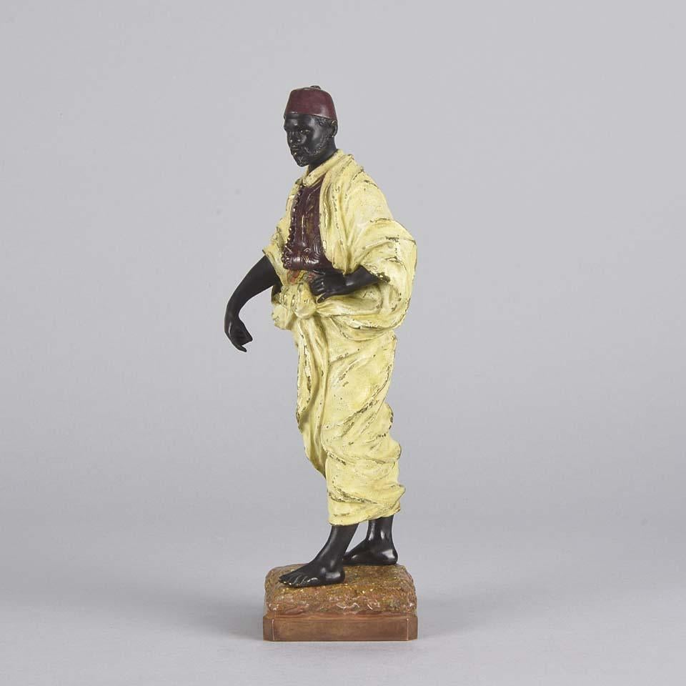 Very fine Orientalist styled cold painted Arab bronze figurine modelled as a North African Arab gentleman in full period attire with obligatory fez. The bronze with lightly worn naturalistic color and crisp detail. Signed to back of bronze with the