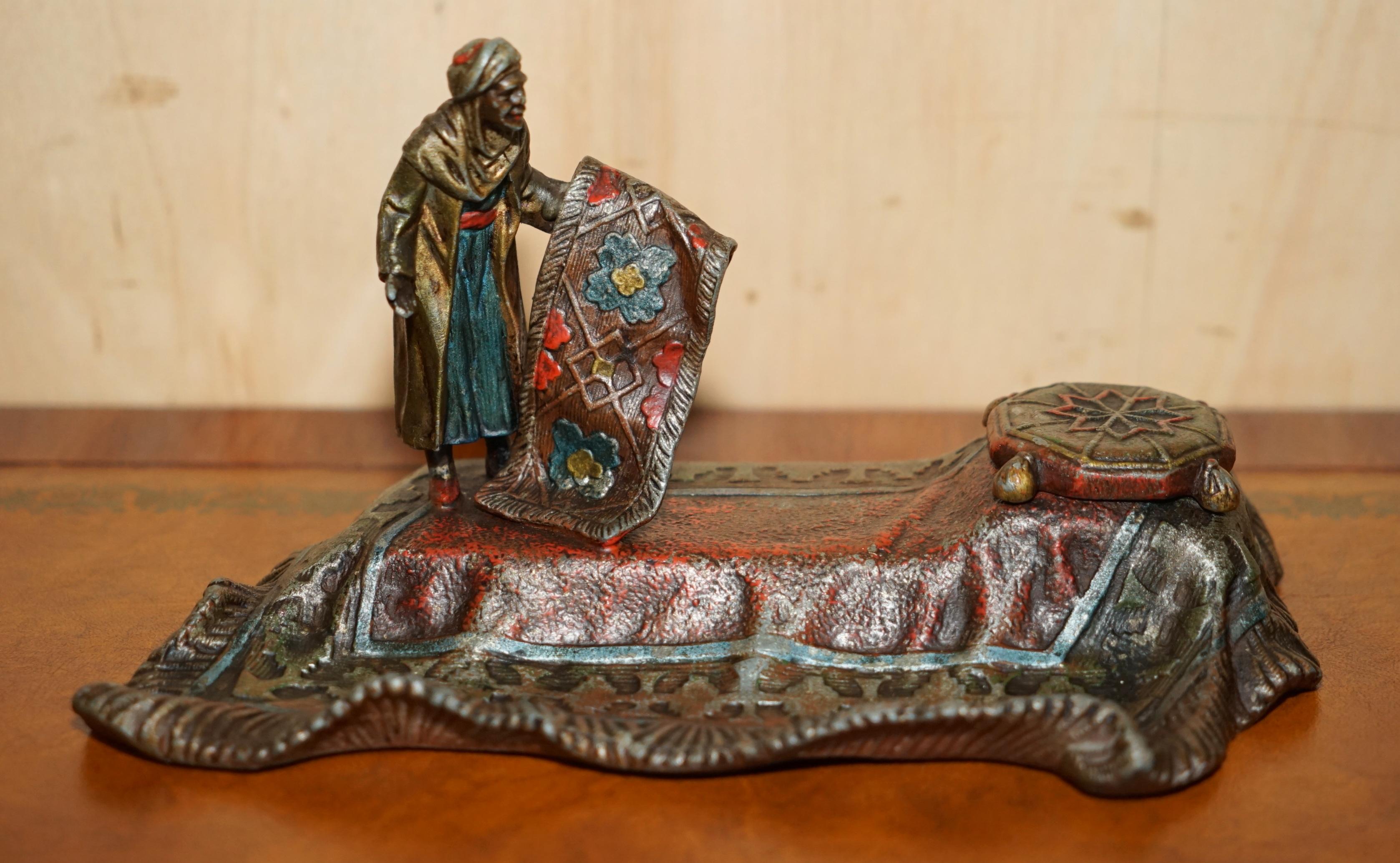 We are delighted to offer for sale this lovely made in Austria stamped Ink well depicting an Arabic carpet seller which is after and original design by Franz Bergman

This is a very decorative piece, the original is a lamp by Bergman which is around