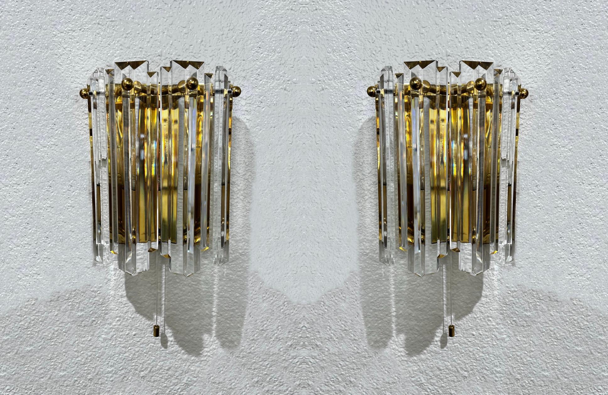 1970’s Glamorous pair of Austrian crystal and brass wall sconces by J.T. Kalmar. 
In original vintage condition, shows minor wear consistent with age(no chips). 
They take one 60w max candelabra light bulb.  Pull down on/off switch. 