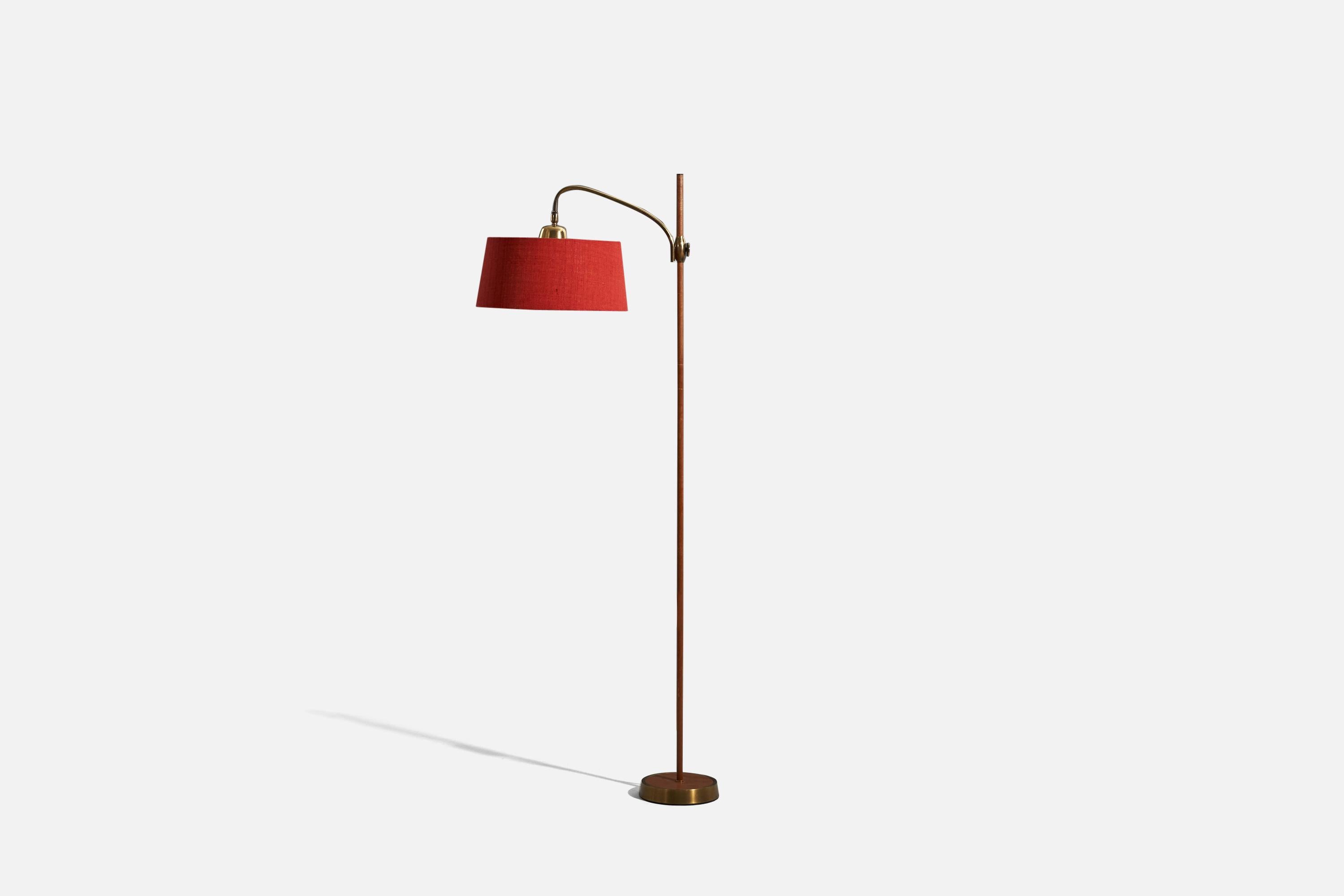 A teak, brass and red fabric floor lamp designed and produced in Austria, c. 1950s.

Variable dimensions, measured as illustrated in the first image.