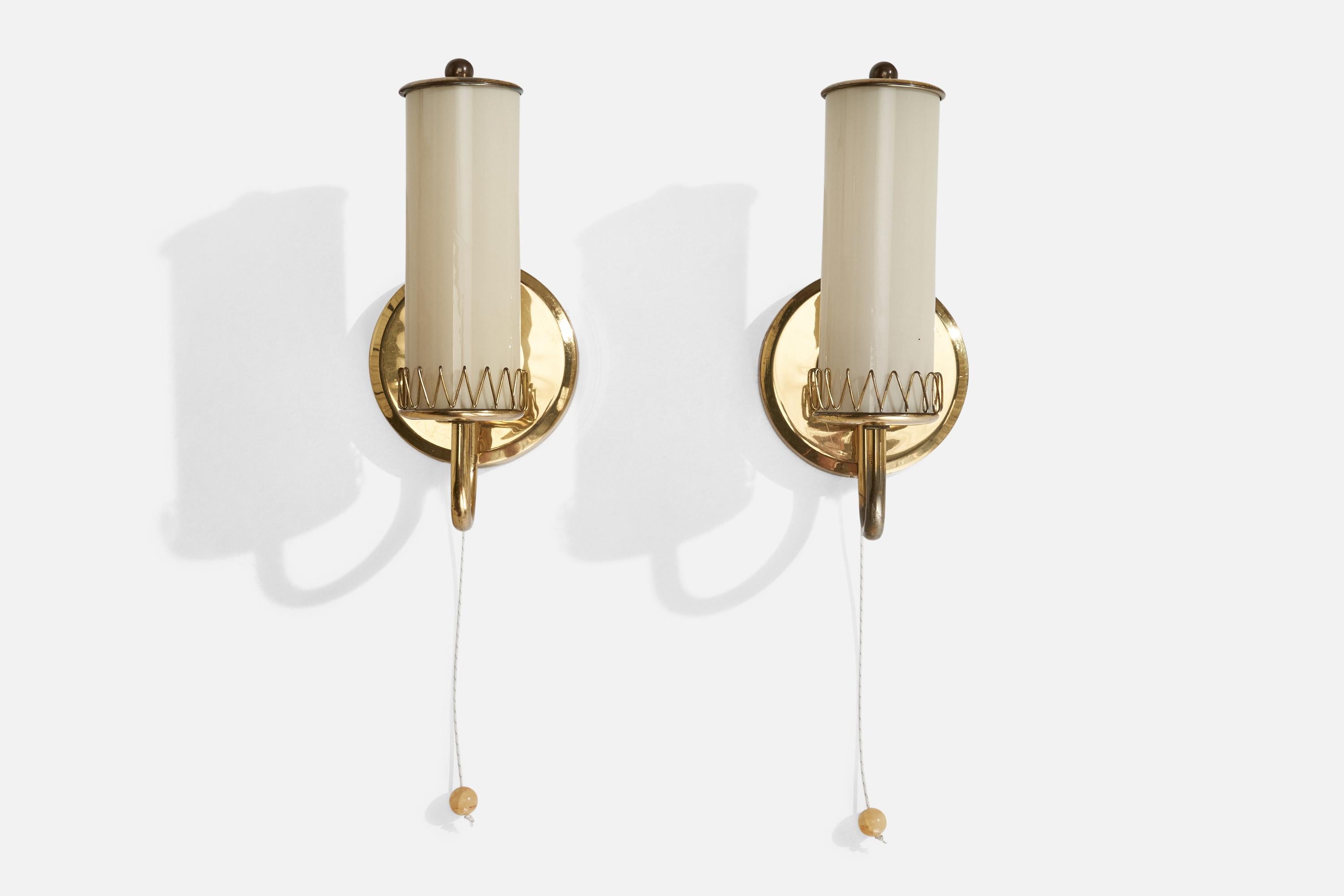 A pair of brass and opaline glass wall lights designed and produced in Austria, c. 1950s.

Overall Dimensions (inches): 9.25” H x 4.44” W x 4.37” D
Back Plate Dimensions (inches): 4.44” H x 0.57” D
Bulb Specifications: E-14 Bulb
Number of Sockets:
