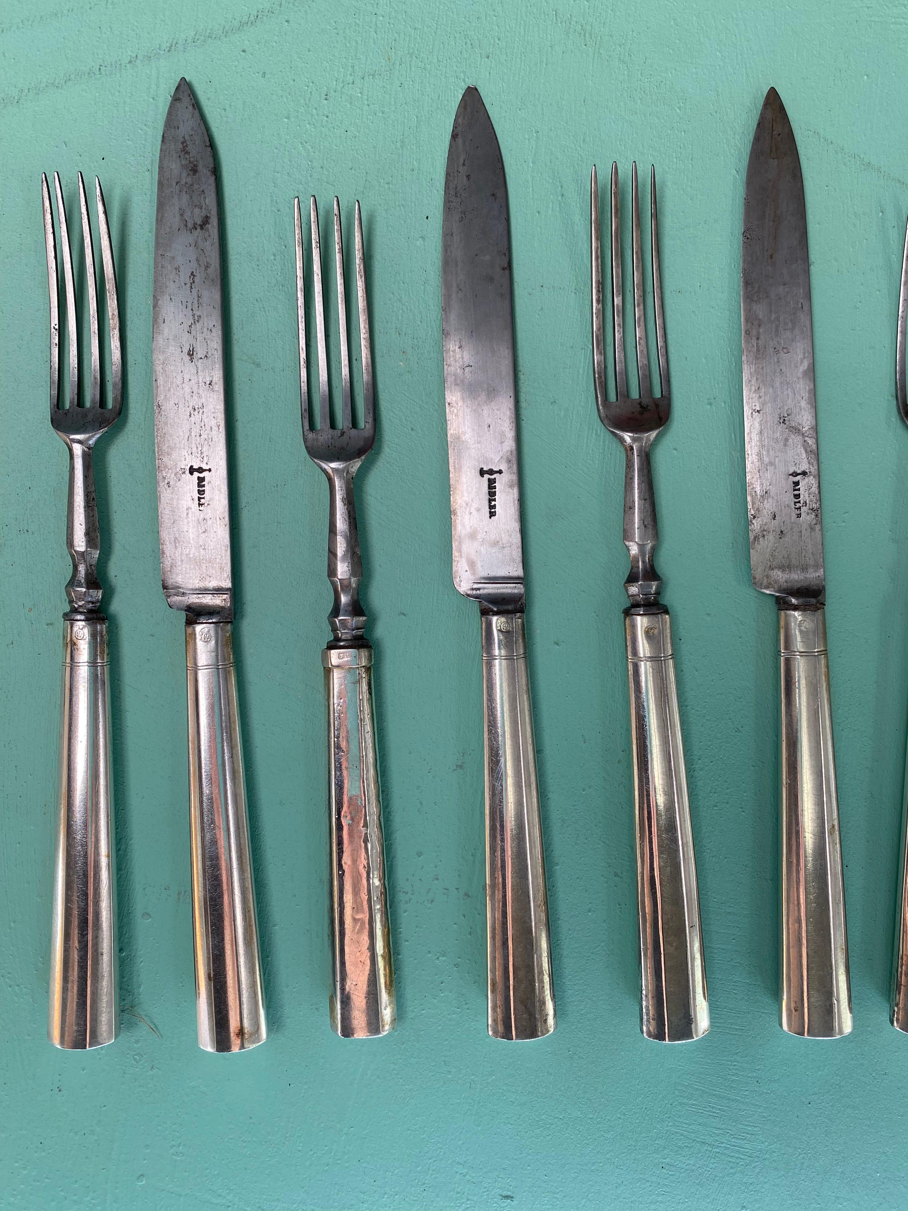 An impressive set of twelve early nineteenth century Neoclassical knives and forks with Austrian Empire sterling silver handles and original early 19th century steel blades. Original or appropriate-to-period box included. 

The blades stamped with