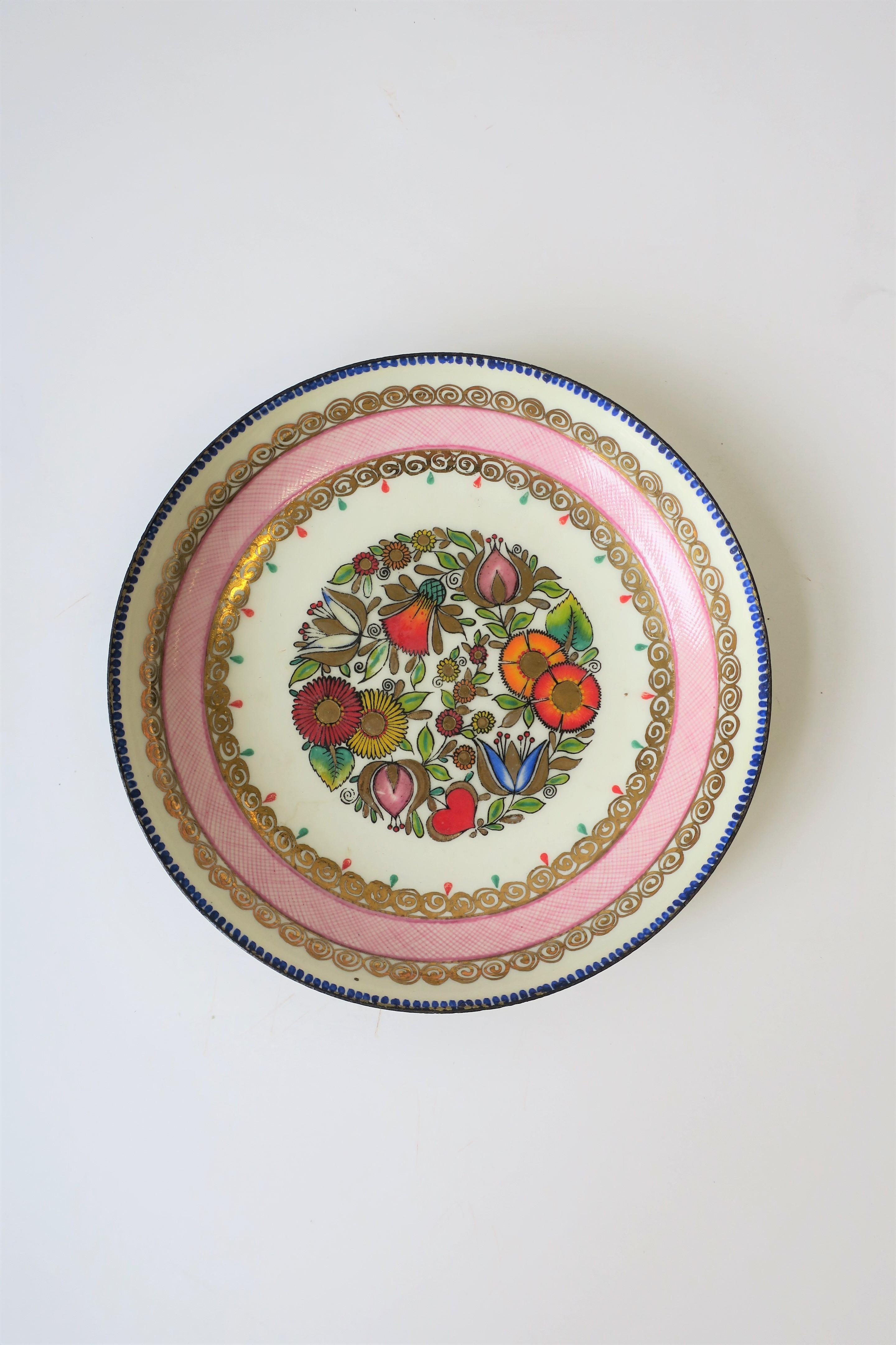 A colorful porcelain enamel Austrian bowl, jewelry dish or vide-poche (catch-all), circa mid-20th century, Austria. Dish has detailed enamel design of flowers, leaves, and swirls. Marked 