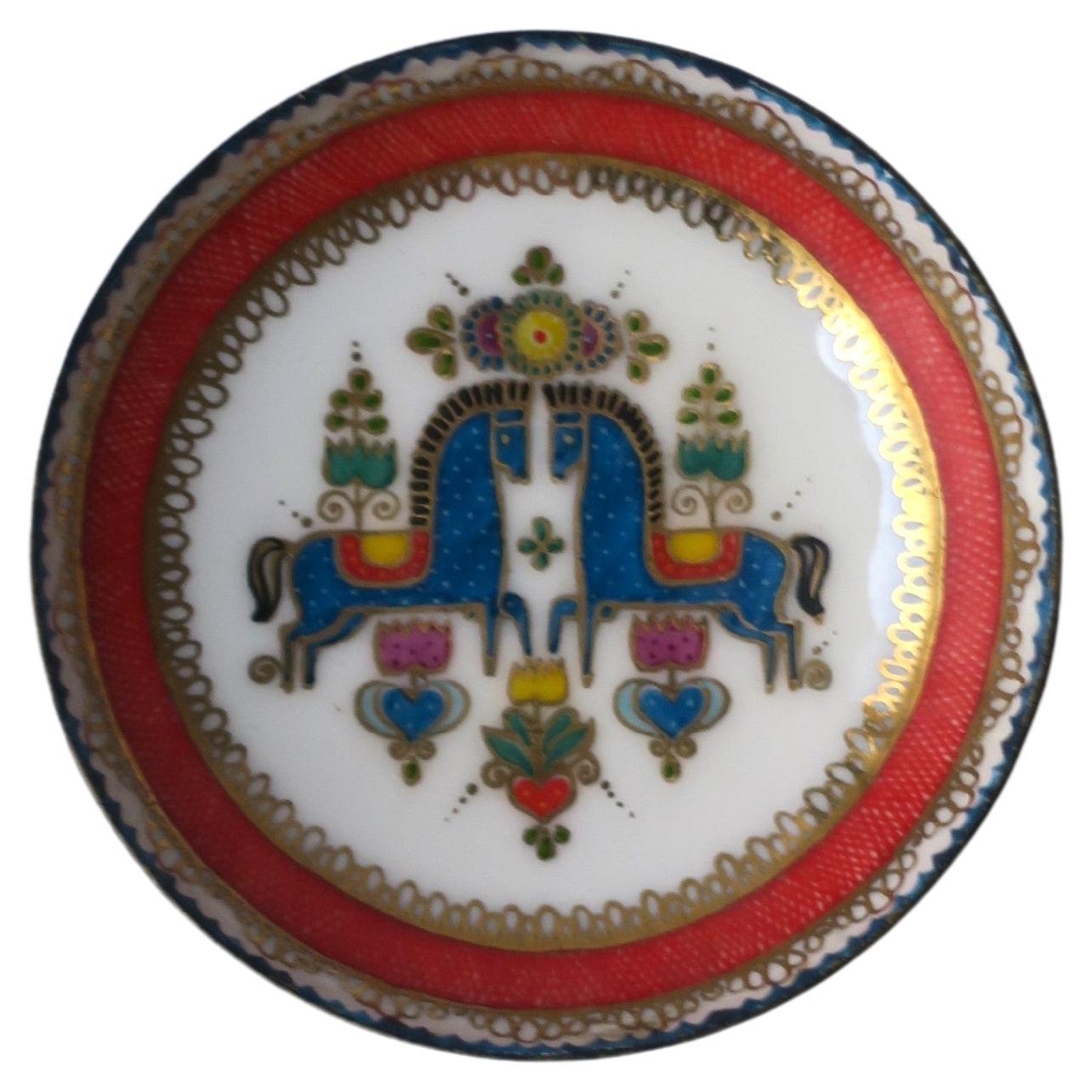 A colorful porcelain enamel Austrian small bowl or jewelry dish, circa mid-20th century, Austria. Dish, with a white enamel ground, features detailed Austrian horses at center, finished with red and gold detail around inside edge. A great piece for