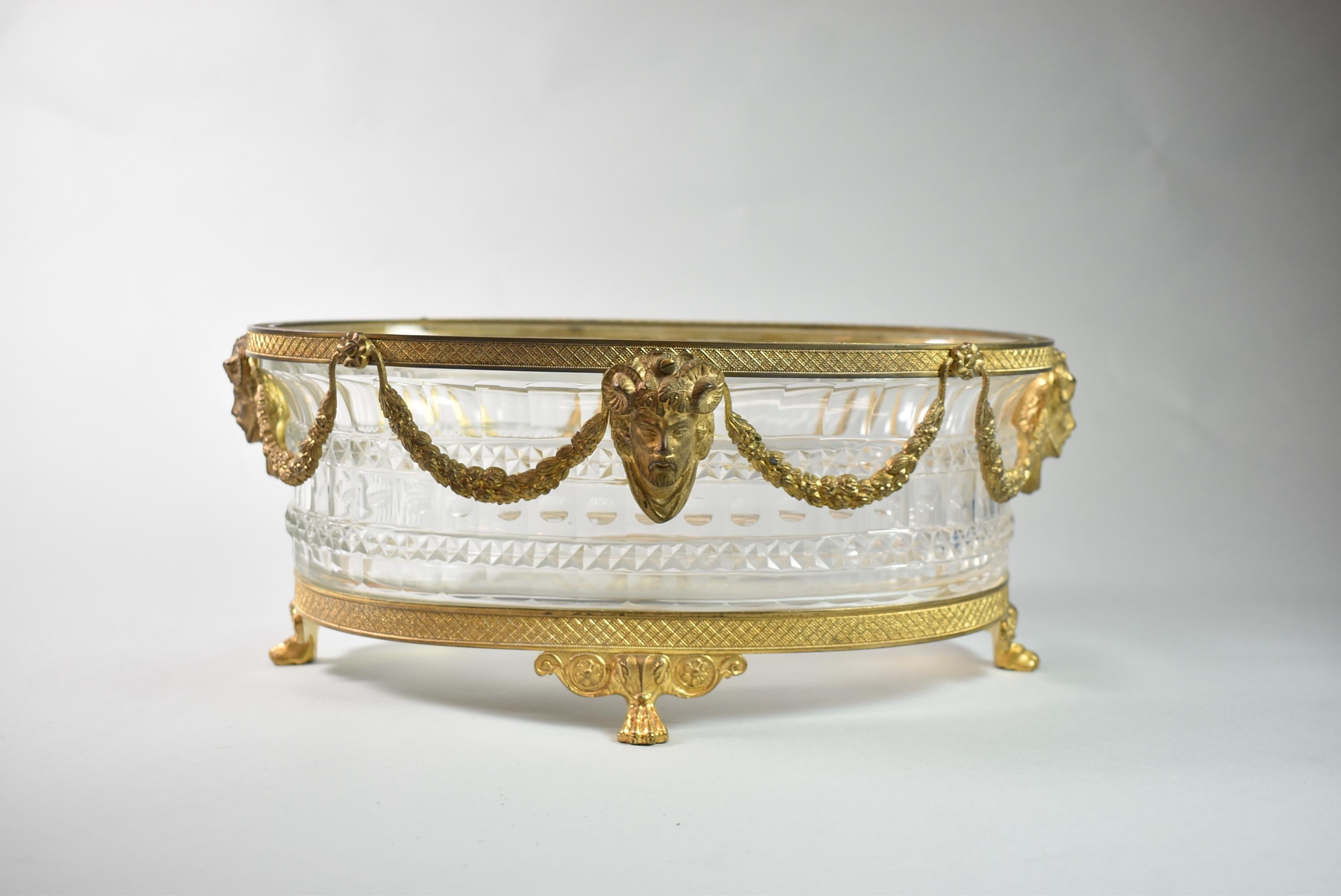 Crystal centerpiece bowl with gilt bronze edge and footed paw base, featuring figural goat and man fauns, cut crystal Dore, Austrian. Very good to excellent condition. Dimensions: 9