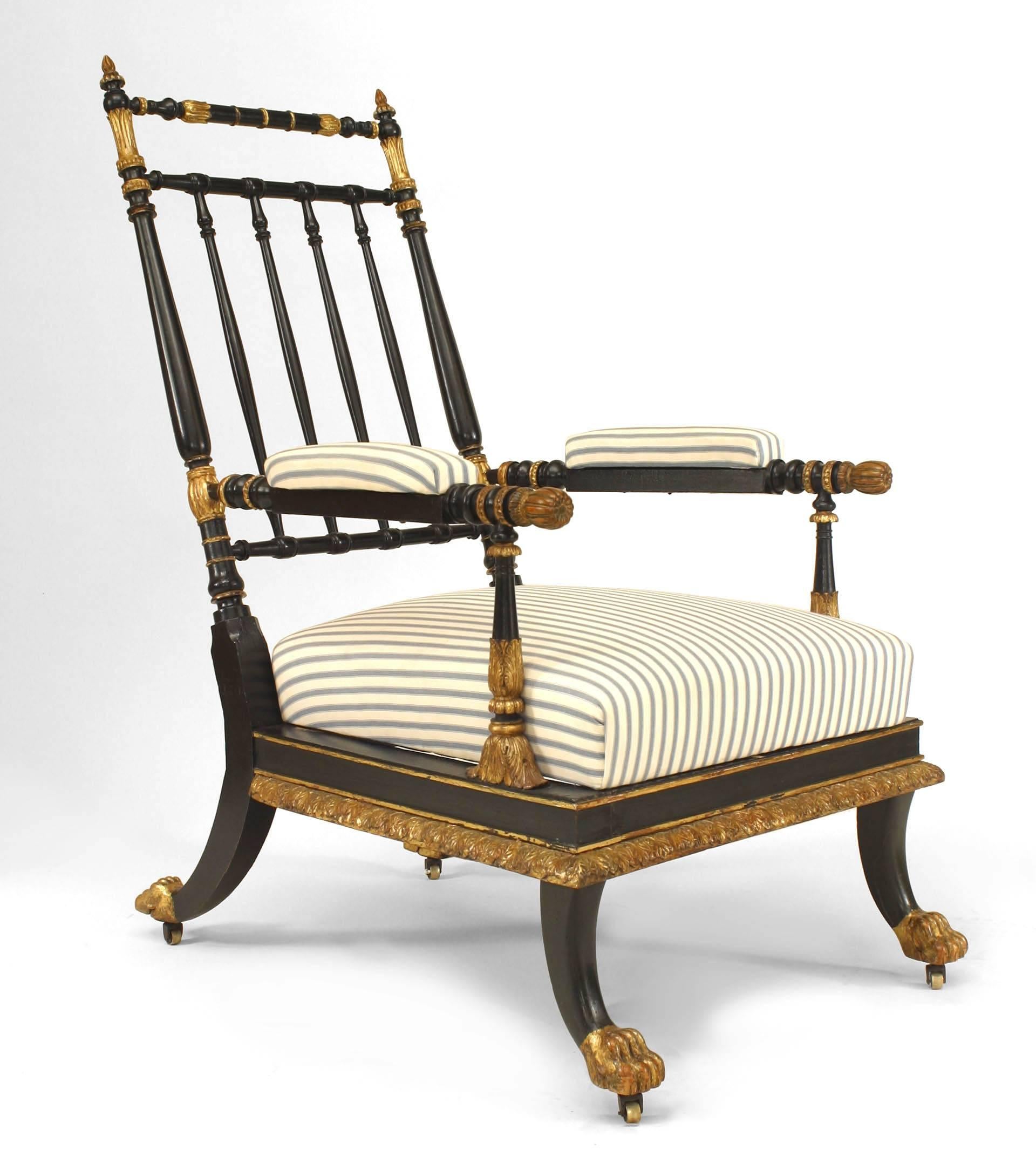 Early nineteenth century Continental Austrian ebonized and gilt trimmed open armchair with a spindle design back and gilt foliate relief apron over sabre form legs with upholstered seat and arm rests.